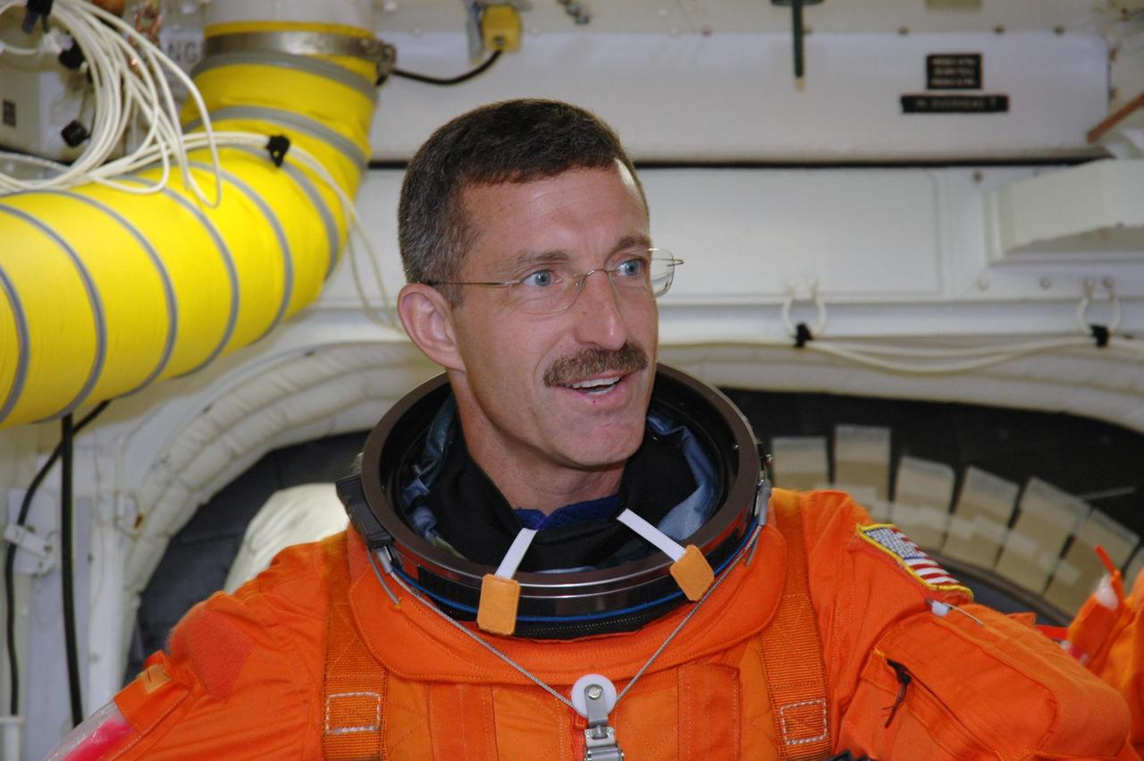 KENNEDY SPACE CENTER, FLA. -  The STS-115 crew members complete their suitup in the White Room before entering Space Shuttle Atlantis on Launch Pad 39B for a simulated launch countdown.  Shown here is Mission Specialist Daniel Burbank.  The White Room, which is located at the end of the orbiter access arm, allows entry into the orbiter through the crew access hatch.  The mission crew is at KSC for Terminal Countdown Demonstration Test (TCDT) activities that are preparation for launch.  Liftoff of Atlantis is scheduled to take place in a window that opens Aug. 27.  During their 11-day mission to the International Space Station, the STS-115 crew will continue construction of the station and attach the payload elements, the Port 3/4 truss segment with its two large solar arrays.  Photo credit: NASA/Jim Grossmann