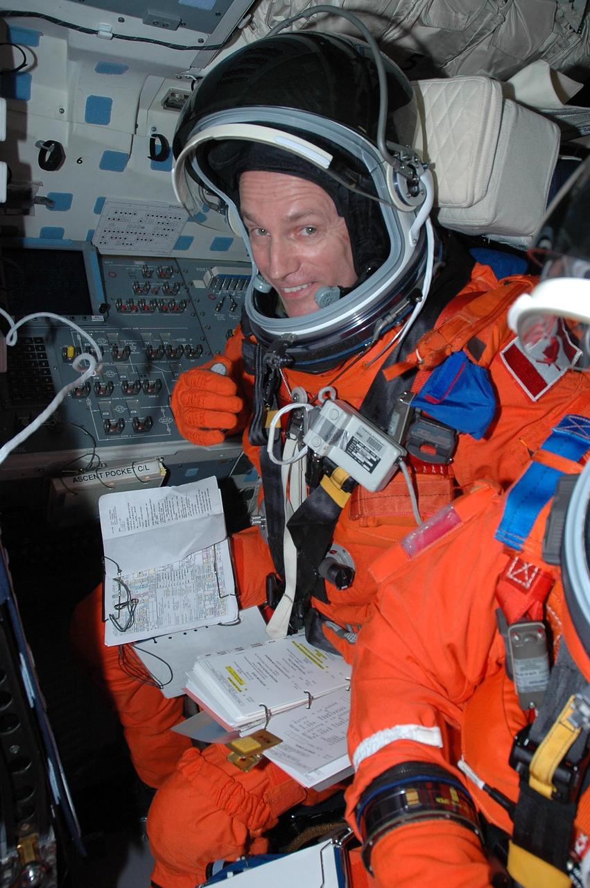 KENNEDY SPACE CENTER, FLA. - Inside Atlantis' cockpit, STS-115 Mission Specialist Steven MacLean is taking part in a simulated launch countdown, the culmination of Terminal Countdown Demonstration Test activities. MacLean is with the Canadian Space Agency. The TCDT is a prelaunch preparation for the mission that is scheduled to lift off in a window opening Aug. 27. During their 11-day mission to the International Space Station, the STS-115 crew will continue construction of the station and attach the payload elements, the Port 3/4 truss segment with its two large solar arrays.