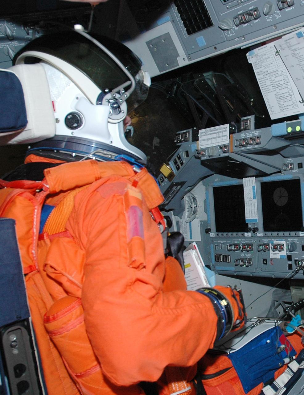 KENNEDY SPACE CENTER, FLA. - Inside Atlantis' cockpit, STS-115 Commander Brent Jett is taking part in a simulated launch countdown, the culmination of Terminal Countdown Demonstration Test activities. The TCDT is a prelaunch preparation for the mission that is scheduled to lift off in a window opening Aug. 27. During their 11-day mission to the International Space Station, the STS-115 crew will continue construction of the station and attach the payload elements, the Port 3/4 truss segment with its two large solar arrays.