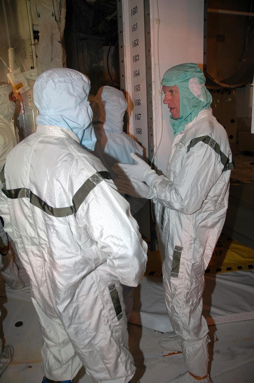 KENNEDY SPACE CENTER, FLA. -    In the payload changeout room on Launch Pad 39B, STS-115 crew members look over the mission payload one more time before launch. At right is commander Brett Jett. The mission crew has been at KSC to take part in Terminal Countdown Demonstration Test activities, which include emergency egress training, a simulated launch countdown and the payload familiarization. The TCDT is a prelaunch preparation for the mission that is scheduled to lift off in a window opening Aug. 27. During their 11-day mission to the International Space Station, the STS-115 crew will continue construction of the station and attach the payload elements, the Port 3/4 truss segment with its two large solar arrays. Photo credit: NASA/Cory Huston
