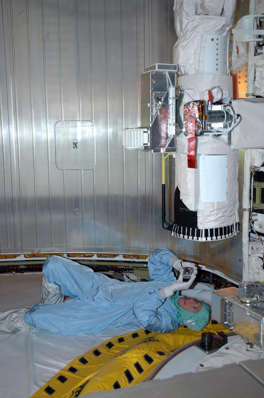 KENNEDY SPACE CENTER, FLA. -    In the payload changeout room on Launch Pad 39B, STS-115 pilot Christopher Ferguson looks over the mission payload one more time before launch. The mission crew has been at KSC to take part in Terminal Countdown Demonstration Test activities, which include emergency egress training, a simulated launch countdown and the payload familiarization. The TCDT is a prelaunch preparation for the mission that is scheduled to lift off in a window opening Aug. 27. During their 11-day mission to the International Space Station, the STS-115 crew will continue construction of the station and attach the payload elements, the Port 3/4 truss segment with its two large solar arrays. Photo credit: NASA/Cory Huston