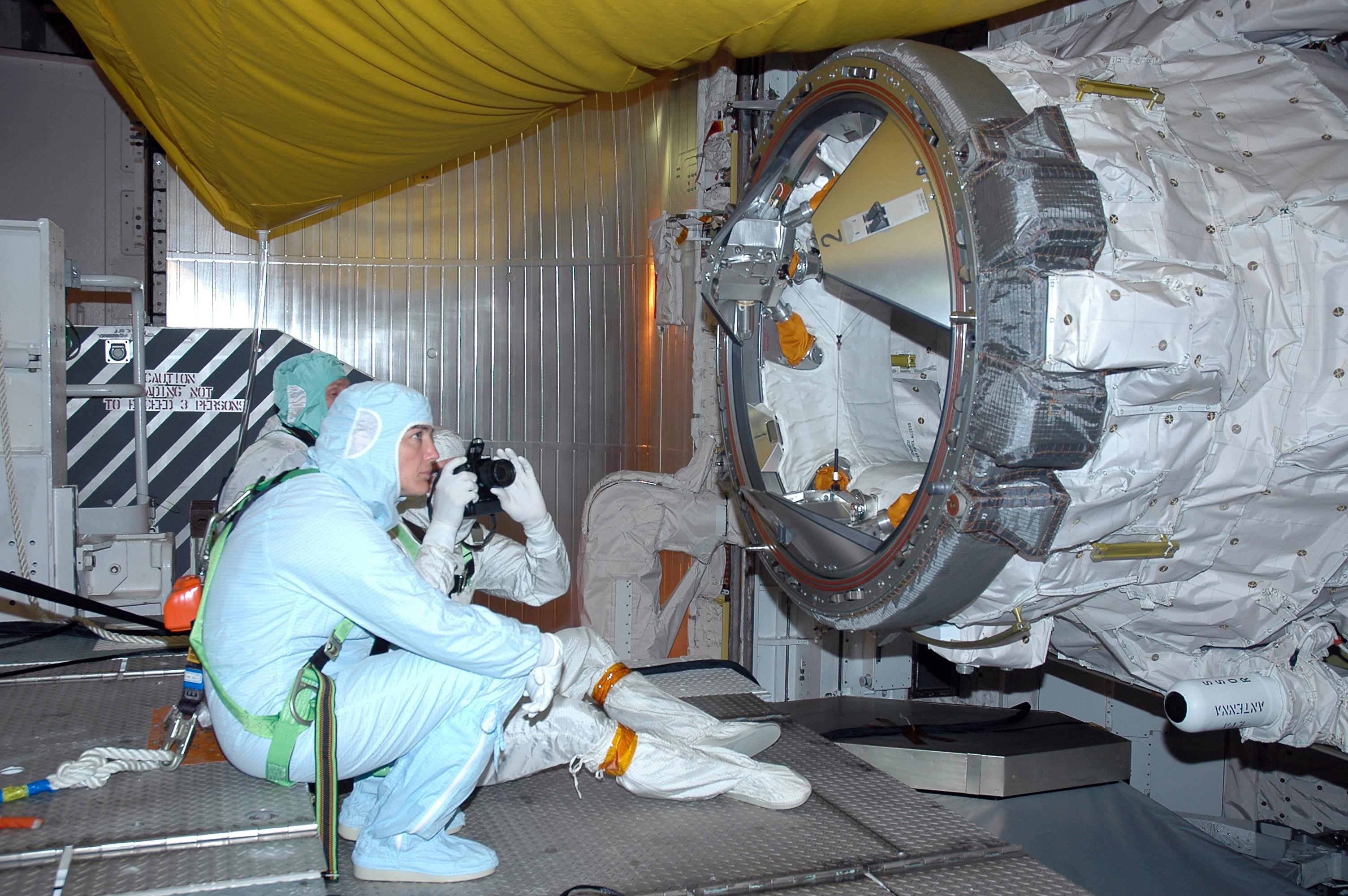 KENNEDY SPACE CENTER, FLA. -    In the payload changeout room on Launch Pad 39B, STS-115 crew members look over the mission payload one more time before launch. In front is mission specialist Heidemarie Stefanyshyn-Piper. Mission specialist Joseph Tanner is holding a camera, and behind him is mission specialist Steven MacLean, representing the Canadian Space Agency. The mission crew has been at KSC to take part in Terminal Countdown Demonstration Test activities, which include emergency egress training, a simulated launch countdown and the payload familiarization. The TCDT is a prelaunch preparation for the mission that is scheduled to lift off in a window opening Aug. 27. During their 11-day mission to the International Space Station, the STS-115 crew will continue construction of the station and attach the payload elements, the Port 3/4 truss segment with its two large solar arrays. Photo credit: NASA/Cory Huston