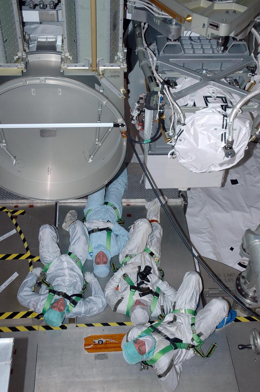 KENNEDY SPACE CENTER, FLA. -    In the payload changeout room on Launch Pad 39B, STS-115 crew members look over the mission payload one more time before launch. Looking up at the payload from left, are mission specialists Steven MacLean, who represents the Canadian Space Agency, Heidemarie Stefanyshyn-Piper, Joseph Tanner, and Daniel Burbank. The mission crew has been at KSC to take part in Terminal Countdown Demonstration Test activities, which include emergency egress training, a simulated launch countdown and the payload familiarization. The TCDT is a prelaunch preparation for the mission that is scheduled to lift off in a window opening Aug. 27. During their 11-day mission to the International Space Station, the STS-115 crew will continue construction of the station and attach the payload elements, the Port 3/4 truss segment with its two large solar arrays. Photo credit: NASA/Cory Huston