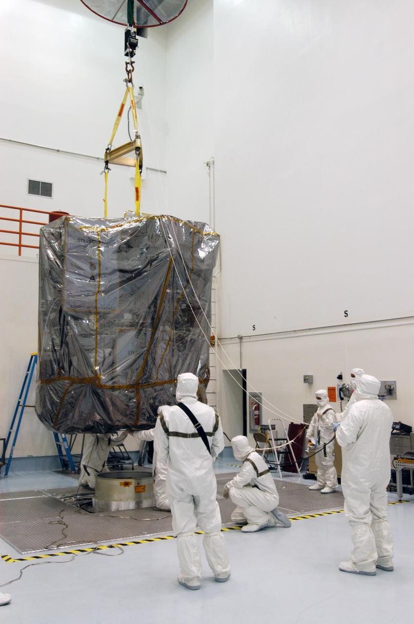 KENNEDY SPACE CENTER, FLA. - At Astrotech Space Operations in Titusville, Fla., workers guide the lifting of the STEREO payload to move it for mating to the upper stage booster. After the mating, all will be transported to Launch Pad 17-B at Cape Canaveral Air Force Station for integration with the Delta II already on the pad. STEREO stands for Solar Terrestrial Relations Observatory and comprises two spacecraft. The STEREO mission is the first to take measurements of the sun and solar wind in 3-dimension. This new view will improve our understanding of space weather and its impact on the Earth. STEREO is expected to lift off Aug. 31. Photo credit: NASA/George Shelton