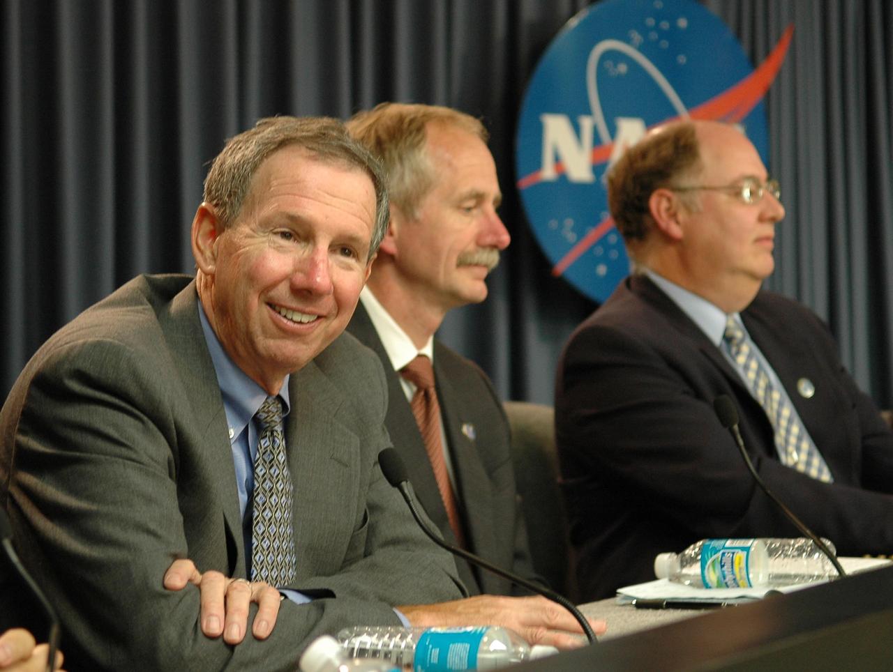 KENNEDY SPACE CENTER, FLA. - At a press conference following the Flight Readiness Review, a thorough assessment of preparations for the mission, NASA Administrator Mike Griffin is amused by a question from the media. Next to Griffin on the dais are Bill Gerstenmaier, associate administrator for Space Operations, and Wayne Hale, Space Shuttle Program manager. Also present at the conference, but not pictured, is Mike Leinbach, NASA launch director. Griffin confirmed the final launch date of Aug. 27 for mission STS-115. Mission STS-115 continues the assembly of the International Space Station with the installation of the truss segments P3 and P4. Liftoff of Space Shuttle Atlantis on mission STS-115 is targeted at approximately 4:30 p.m. EDT on Aug. 27. Photo credit: NASA/Kim Shiflett