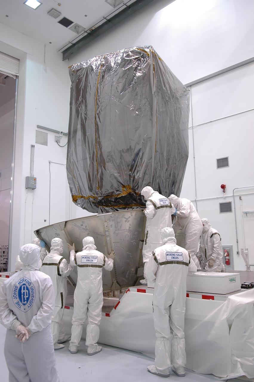 KENNEDY SPACE CENTER, FLA. - At Astrotech Space Operations in Titusville, Fla., workers begin to install the lower portion of the transportation canister around the upper stage booster attached to the STEREO spacecraft (above). The entire configuration will be encased for the move to Launch Pad 17-B at Cape Canaveral Air Force Station. STEREO stands for Solar Terrestrial Relations Observatory and comprises two spacecraft. The STEREO mission is the first to take measurements of the sun and solar wind in 3-dimension. This new view will improve our understanding of space weather and its impact on the Earth. STEREO is expected to lift off Aug. 31. Photo credit: NASA/Kim Shiflett
