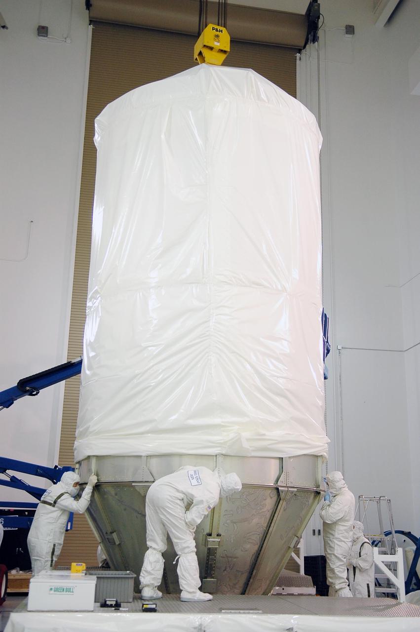 KENNEDY SPACE CENTER, FLA. - At Astrotech Space Operations in Titusville, Fla., workers check the fitting of the upper portion of the transportation canister onto the lower portion. The canister encases the STEREO spacecraft for its move to Launch Pad 17-B at Cape Canaveral Air Force Station. STEREO stands for Solar Terrestrial Relations Observatory and comprises two spacecraft. The STEREO mission is the first to take measurements of the sun and solar wind in 3-dimension. This new view will improve our understanding of space weather and its impact on the Earth. STEREO is expected to lift off Aug. 31. Photo credit: NASA/Kim Shiflett