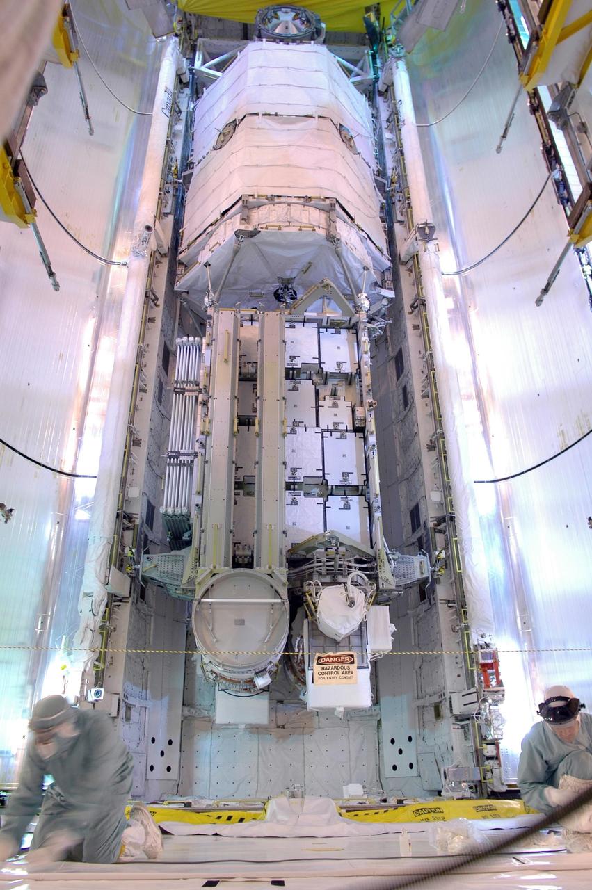 KENNEDY SPACE CENTER, FLA. -  On Launch Pad 39B, Space Shuttle Atlantis' payload bay doors are being closed for launch.  Inside is seen the orbiter's cargo, the 17-and-a-half-ton P3/P4 truss segment for the International Space Station.  Mission STS-115 is scheduled to lift off about 4:30 p.m. Aug. 27.  The crew will deliver and install the P3/P4 segment to the port side of the integrated truss system on the International Space Station.  The truss includes a new set of photovoltaic solar arrays.  When unfurled to their full length of 240 feet, the arrays will provide additional power for the station in preparation for the delivery of international science modules over the next two years.  The mission is expected to last 11 days and includes three scheduled spacewalks.   Photo credit: NASA/Kim Shiflett