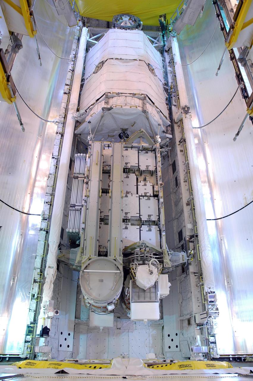 KENNEDY SPACE CENTER, FLA. -   On Launch Pad 39B, Space Shuttle Atlantis' payload bay doors are being closed for launch.  Inside is seen the orbiter's cargo, the 17-and-a-half-ton P3/P4 truss segment for the International Space Station. Scheduled to launch Aug. 27, Atlantis will fly on mission STS-115 with a crew of six to deliver and install the P3/P4 segment to the port side of the integrated truss system on the orbital outpost.  The truss includes a new set of photovoltaic solar arrays.  When unfurled to their full length of 240 feet, the arrays will provide additional power for the station in preparation for the delivery of international science modules over the next two years.  STS-115 is expected to last 11 days and includes three scheduled spacewalks.   Photo credit: NASA/Jim Grossmann