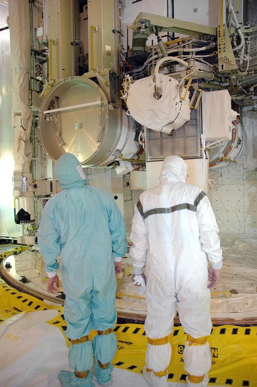 KENNEDY SPACE CENTER, FLA. -    Workers on Launch Pad 39B watch closely as Space Shuttle Atlantis' payload bay doors begin to close.  Inside the payload bay is the orbiter's cargo, the 17-and-a-half-ton P3/P4 truss segment for the International Space Station. Scheduled to launch Aug. 27, Atlantis will fly on mission STS-115 with a crew of six to deliver and install the P3/P4 segment to the port side of the integrated truss system on the orbital outpost.  The truss includes a new set of photovoltaic solar arrays.  When unfurled to their full length of 240 feet, the arrays will provide additional power for the station in preparation for the delivery of international science modules over the next two years.  STS-115 is expected to last 11 days and includes three scheduled spacewalks.  Photo credit: NASA/Jack Pfaller
