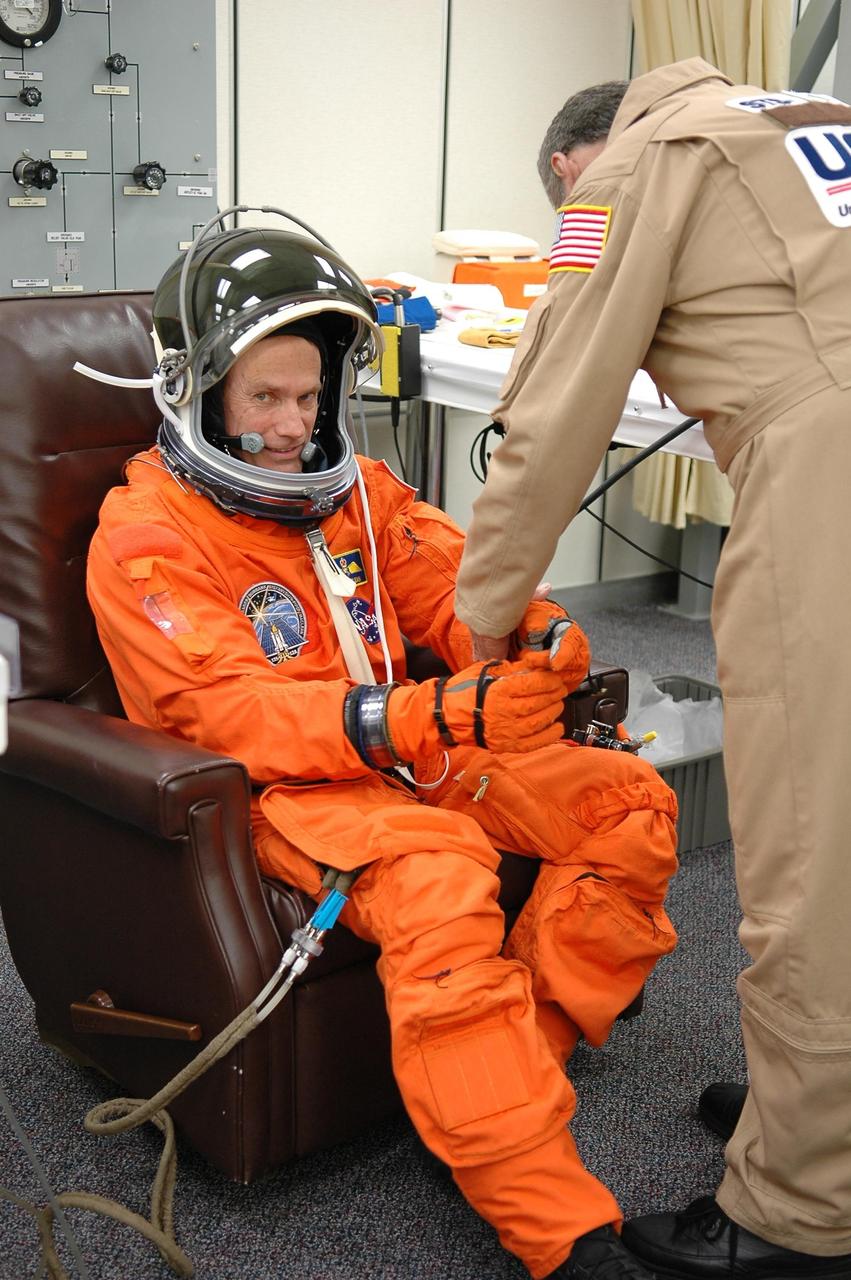 KENNEDY SPACE CENTER, FLA. - STS-115 Mission Specialist Steven MacLean has his launch suit checked for fit before the launch on Aug. 27. MacLean, who represents the Canadian Space Agency, will be making his second flight on a shuttle. Mission STS-115 is scheduled to lift off about 4:30 p.m. Aug. 27 on Space Shuttle Atlantis. The crew will deliver and install the P3/P4 segment to the port side of the integrated truss system on the International Space Station. The truss includes a new set of photovoltaic solar arrays. When unfurled to their full length of 240 feet, the arrays will provide additional power for the station in preparation for the delivery of international science modules over the next two years. The mission is expected to last 11 days and includes three scheduled spacewalks. Photo credit: NASA/Kim Shiflett