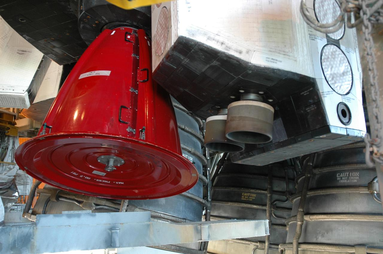 KENNEDY SPACE CENTER, FLA. - Preparations continue on the pad for launch of Atlantis on mission STS-115 as early as Aug. 29. However, preparations are also underway for a rollback of Atlantis to the Vehicle Assembly Building due to Hurricane Ernesto. The red cover seen here on Space Shuttle Atlantis' orbital maneuvering system pod nozzle will be removed before launch. However, in the event of a rollback, the cover will be left attached. The rollback will be determined by the mission management team based on information about Hurricane Ernesto and its path through Florida. Atlantis has been poised on Launch Pad 39B for liftoff on mission STS-115 to the International Space Station to deliver the P3/P4 truss segment. Photo credit: NASA/Jack Pfaller