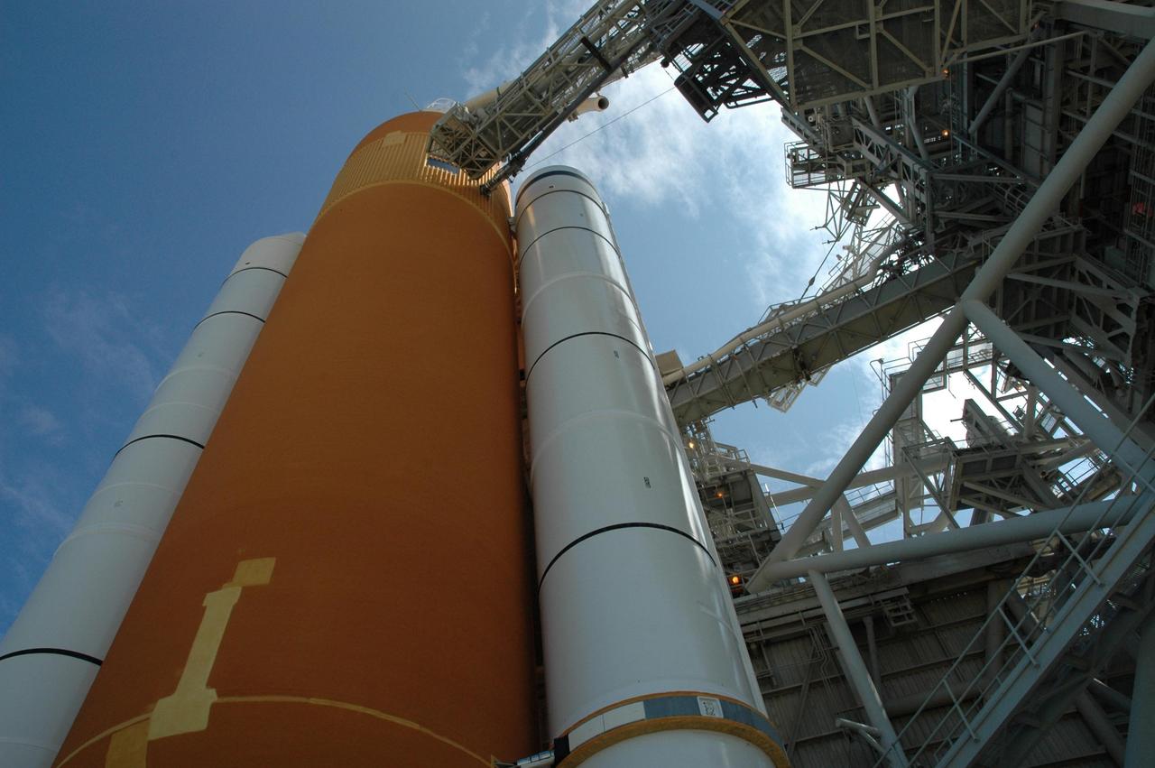 KENNEDY SPACE CENTER, FLA. - Seen on Launch Pad 39B, the looming external tank (center) flanked by the solid rocket boosters hide Space Shuttle Atlantis, behind them. Near the top of the external tank is the liquid hydrogen vent arm. Preparations continue on the pad for launch of Atlantis on mission STS-115 as early as Aug. 29. However, preparations are also underway for a rollback of Atlantis to the Vehicle Assembly Building due to Hurricane Ernesto. The rollback will be determined by the mission management team based on information about Hurricane Ernesto and its path through Florida. Atlantis has been poised on Launch Pad 39B for liftoff on mission STS-115 to the International Space Station to deliver the P3/P4 truss segment. Photo credit: NASA/Jack Pfaller