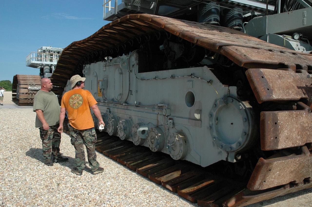 KENNEDY SPACE CENTER, FLA. -  Workers check on the crawler-transporters in the event they are needed for rolling back Space Shuttle Atlantis from Launch Pad 39B. Crawler No. 2 will be used to move the STS-116 stack from VAB high bay 3 to high bay 2 and crawler No. 1 will be used to transport Atlantis to high bay 3. The rollback will be determined by the mission management team based on information about Hurricane Ernesto and its path through Florida. Atlantis has been poised on Launch Pad 39B for liftoff on mission STS-115 to the International Space Station to deliver the P3/P4 truss segment.  Photo credit: NASA/Jack Pfaller