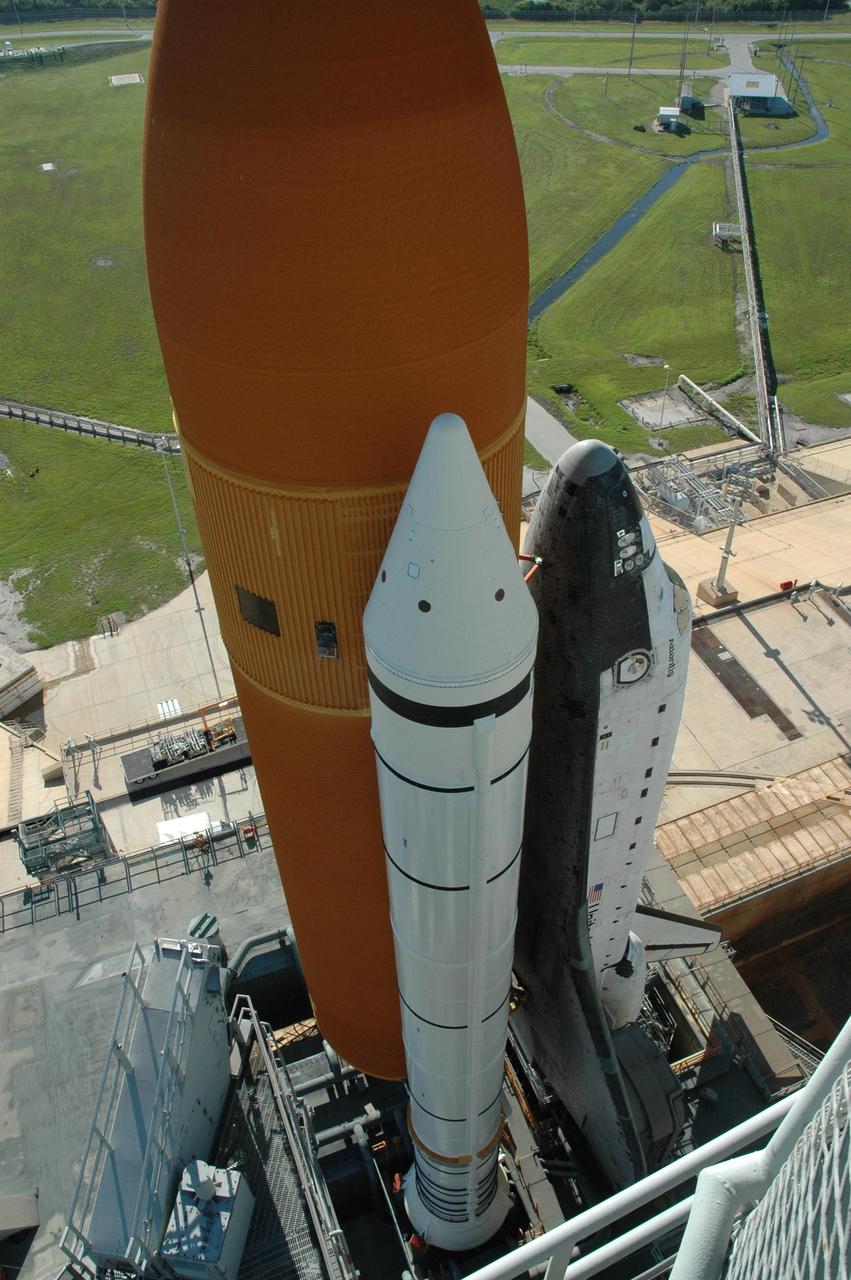 KENNEDY SPACE CENTER, FLA. - Viewed from an upper level of the fixed service structure on Launch Pad 39B, Space Shuttle Atlantis begins rolling back to the Vehicle Assembly Building. First motion was at 10:04 a.m. The rollback is a safety precaution as the area waits for the arrival of Tropical Storm Ernesto. The storm is forecast to be bringing 58-mph to 70-mph winds in the next 24 hours. The shuttle will be moved into high bay 2, on the southwest side of the VAB, for protection from the storm. Photo credit: NASA/Jack Pfaller