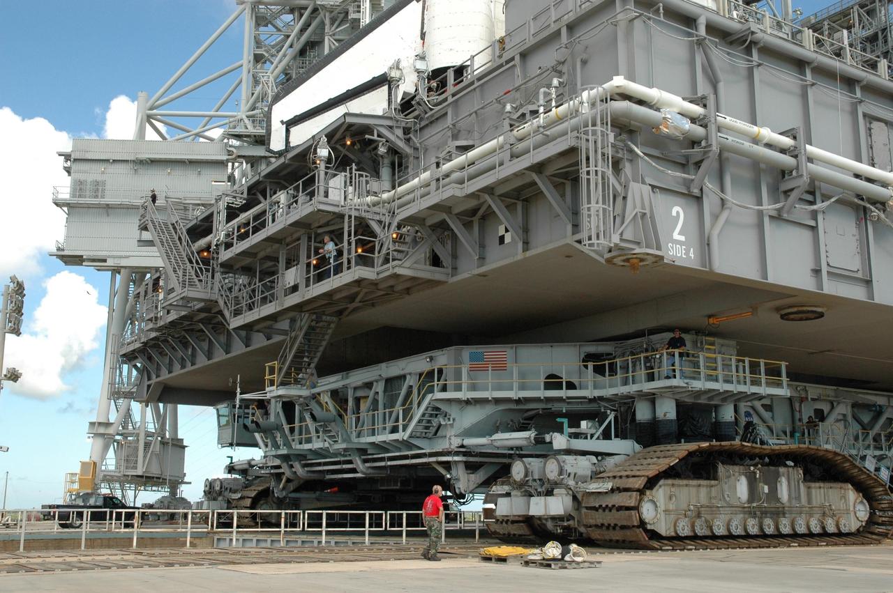 KENNEDY SPACE CENTER, FLA. - The massive mobile launcher platform and Space Shuttle Atlantis above it nearly dwarf the crawler-transporter below them. The crawler alone is 20 feet high. The crawler is moving the Space Shuttle Atlantis and mobile launcher platform back to the Vehicle Assembly Building. First motion off the pad was at 10:04 a.m. EDT. The rollback is a safety precaution as the area waits for the arrival of Tropical Storm Ernesto. The storm is forecast to be bringing 58-mph to 70-mph winds in the next 24 hours. The shuttle will be moved into high bay 2, on the southwest side of the VAB, for protection from the storm. Photo credit: NASA/Jack Pfaller