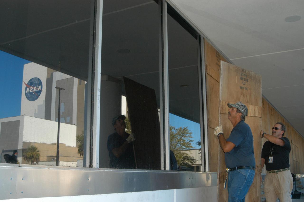 KENNEDY SPACE CENTER, FLA. - NASA's Kennedy Space Center has begun making preparations for the arrival of Tropical Storm Ernesto. Here workers are boarding up windows on the Operations and Support Building I in the Launch Complex 39 Area. The center has been in HURCON III status since Aug. 28, which means winds of 58 mph are expected within 48 hours. m. Photo credit: NASA/George Shelton