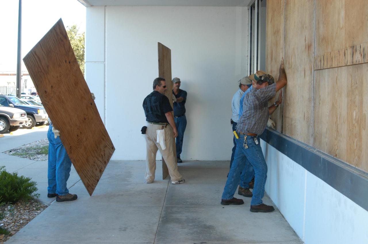 KENNEDY SPACE CENTER, FLA. - NASA's Kennedy Space Center has begun making preparations for the arrival of Tropical Storm Ernesto. Here workers are boarding up windows on the Operations and Support Building I in the Launch Complex 39 Area. The center has been in HURCON III status since Aug. 28, which means winds of 58 mph are expected within 48 hours. m. Photo credit: NASA/George Shelton