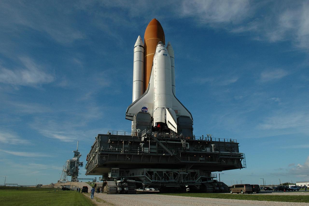 KENNEDY SPACE CENTER, FLA. -  After reversing its direction to the Vehicle Assembly Building, Space Shuttle Atlantis nears Launch Pad 39B. The shuttle is returning to Launch Pad 39B, in the background, after rolling back to the Vehicle Assembly Building due to concerns about the impact of Tropical Storm Ernesto.  However, before reaching the VAB, the  forecast of lesser winds expected from Ernesto and its projected direction convinced Launch Integration Manager LeRoy Cain and Shuttle Launch Director Mike Leinbach to return the shuttle to the launch pad.  Photo credit: NASA/Kim Shiflett