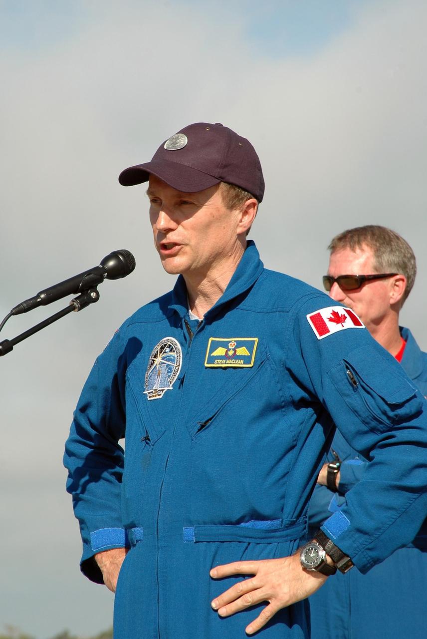 KENNEDY SPACE CENTER, FLA. - The crew of mission STS-115 stop to talk to the media after arriving at NASA Kennedy Space Center's Shuttle Landing Facility to prepare for a second launch attempt on Sept. 6 to the International Space Station. Seen here is Mission Specialist Steven MacLean, who will be making his second flight on the shuttle. MacLean is with the Canadian Space Agency. Mission managers cancelled Atlantis' first launch campaign due to a lightning strike at the pad and the passage of Tropical Storm Ernesto along Florida's east coast. The mission will deliver and install the 17-and-a-half-ton P3/P4 truss segment to the port side of the integrated truss system on the orbital outpost. The truss includes a new set of photovoltaic solar arrays. When unfurled to their full length of 240 feet, the arrays will provide additional power for the station in preparation for the delivery of international science modules over the next two years. STS-115 is expected to last 11 days and includes three scheduled spacewalks. Photo credit: NASA/Kim Shiflett