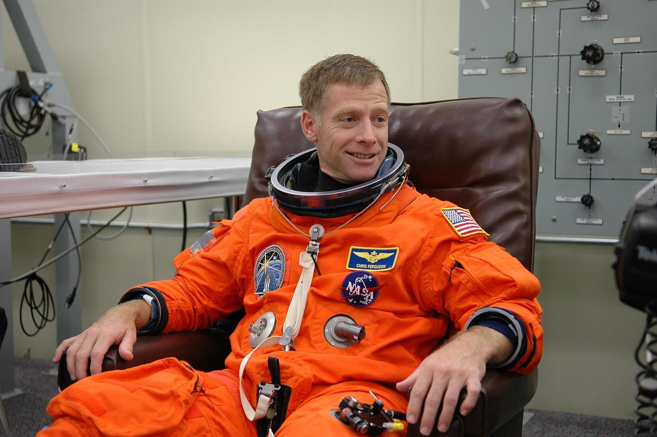 KENNEDY SPACE CENTER, FLA. - STS-115 Pilot Christopher Ferguson dons his launch suit before flying the Shuttle Training Aircraft to practice landing the shuttle. STA practice is part of launch preparations. The STA is a Grumman American Aviation-built Gulf Stream II jet that was modified to simulate an orbiter’s cockpit, motion and visual cues, and handling qualities. In flight, the STA duplicates the orbiter’s atmospheric descent trajectory from approximately 35,000 feet altitude to landing on a runway. Because the orbiter is unpowered during re-entry and landing, its high-speed glide must be perfectly executed the first time. Mission STS-115 is scheduled to lift off about 12:29 p.m. Sept. 6. Mission managers cancelled Atlantis' first launch campaign due to a lightning strike at the pad and the passage of Tropical Storm Ernesto along Florida's east coast. The mission will deliver and install the 17-and-a-half-ton P3/P4 truss segment to the port side of the integrated truss system on the orbital outpost. The truss includes a new set of photovoltaic solar arrays. When unfurled to their full length of 240 feet, the arrays will provide additional power for the station in preparation for the delivery of international science modules over the next two years. STS-115 is expected to last 11 days and includes three scheduled spacewalks. Photo credit: NASA/Kim Shiflett