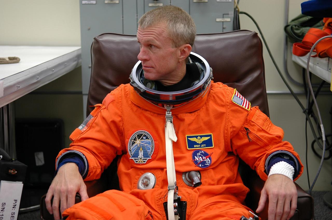 KENNEDY SPACE CENTER, FLA. - STS-115 Commander Brent Jett dons his launch suit before flying the Shuttle Training Aircraft to practice landing the shuttle. STA practice is part of launch preparations. The STA is a Grumman American Aviation-built Gulf Stream II jet that was modified to simulate an orbiter’s cockpit, motion and visual cues, and handling qualities. In flight, the STA duplicates the orbiter’s atmospheric descent trajectory from approximately 35,000 feet altitude to landing on a runway. Because the orbiter is unpowered during re-entry and landing, its high-speed glide must be perfectly executed the first time. Mission STS-115 is scheduled to lift off about 12:29 p.m. Sept. 6. Mission managers cancelled Atlantis' first launch campaign due to a lightning strike at the pad and the passage of Tropical Storm Ernesto along Florida's east coast. The mission will deliver and install the 17-and-a-half-ton P3/P4 truss segment to the port side of the integrated truss system on the orbital outpost. The truss includes a new set of photovoltaic solar arrays. When unfurled to their full length of 240 feet, the arrays will provide additional power for the station in preparation for the delivery of international science modules over the next two years. STS-115 is expected to last 11 days and includes three scheduled spacewalks. Photo credit: NASA/Kim Shiflett