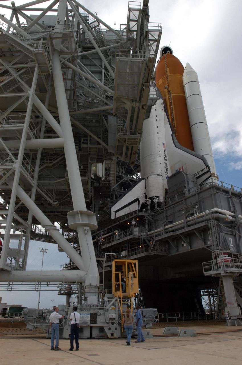 KENNEDY SPACE CENTER, FLA. - The rotating service structure (left) on Launch Pad 39B is ready to roll away from Space Shuttle Atlantis in preparation for launch. The RSS provides protected access to the orbiter for changeout and servicing of payloads at the pad and then is rolled away before liftoff. Atlantis is scheduled to launch Sept. 6 at 12:29 p.m. EDT on mission STS-115. During the mission, Atlantis' astronauts will deliver and install the 17.5-ton, bus-sized P3/P4 integrated truss segment on the station. The girder-like truss includes a set of giant solar arrays, batteries and associated electronics and will provide one-fourth of the total power-generation capability for the completed station. This mission is the 116th space shuttle flight, the 27th flight for orbiter Atlantis, and the 19th U.S. flight to the International Space Station. STS-115 is scheduled to last 11 days with a planned KSC landing at about 8:03 a.m. EDT on Sept. 17. Photo credit: NASA/George Shelton