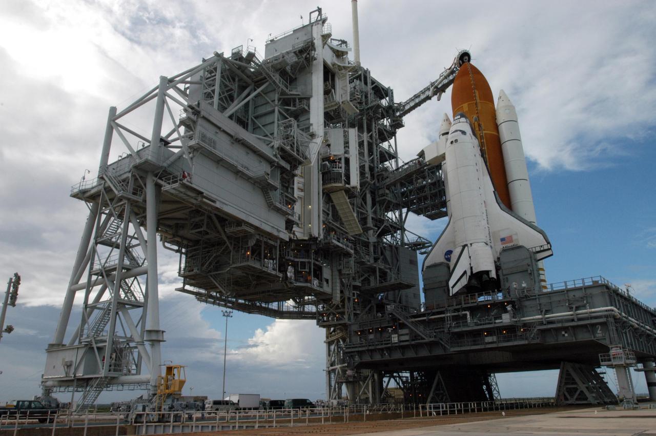 KENNEDY SPACE CENTER, FLA. - The rotating service structure (left) on Launch Pad 39B is rolled back to reveal Space Shuttle Atlantis. The RSS provides protected access to the orbiter for changeout and servicing of payloads at the pad and then is rolled away before liftoff. Atlantis is scheduled to launch Sept. 6 at 12:29 p.m. EDT on mission STS-115. During the mission, Atlantis' astronauts will deliver and install the 17.5-ton, bus-sized P3/P4 integrated truss segment on the station. The girder-like truss includes a set of giant solar arrays, batteries and associated electronics and will provide one-fourth of the total power-generation capability for the completed station. This mission is the 116th space shuttle flight, the 27th flight for orbiter Atlantis, and the 19th U.S. flight to the International Space Station. STS-115 is scheduled to last 11 days with a planned KSC landing at about 8:03 a.m. EDT on Sept. 17. Photo credit: NASA/George Shelton