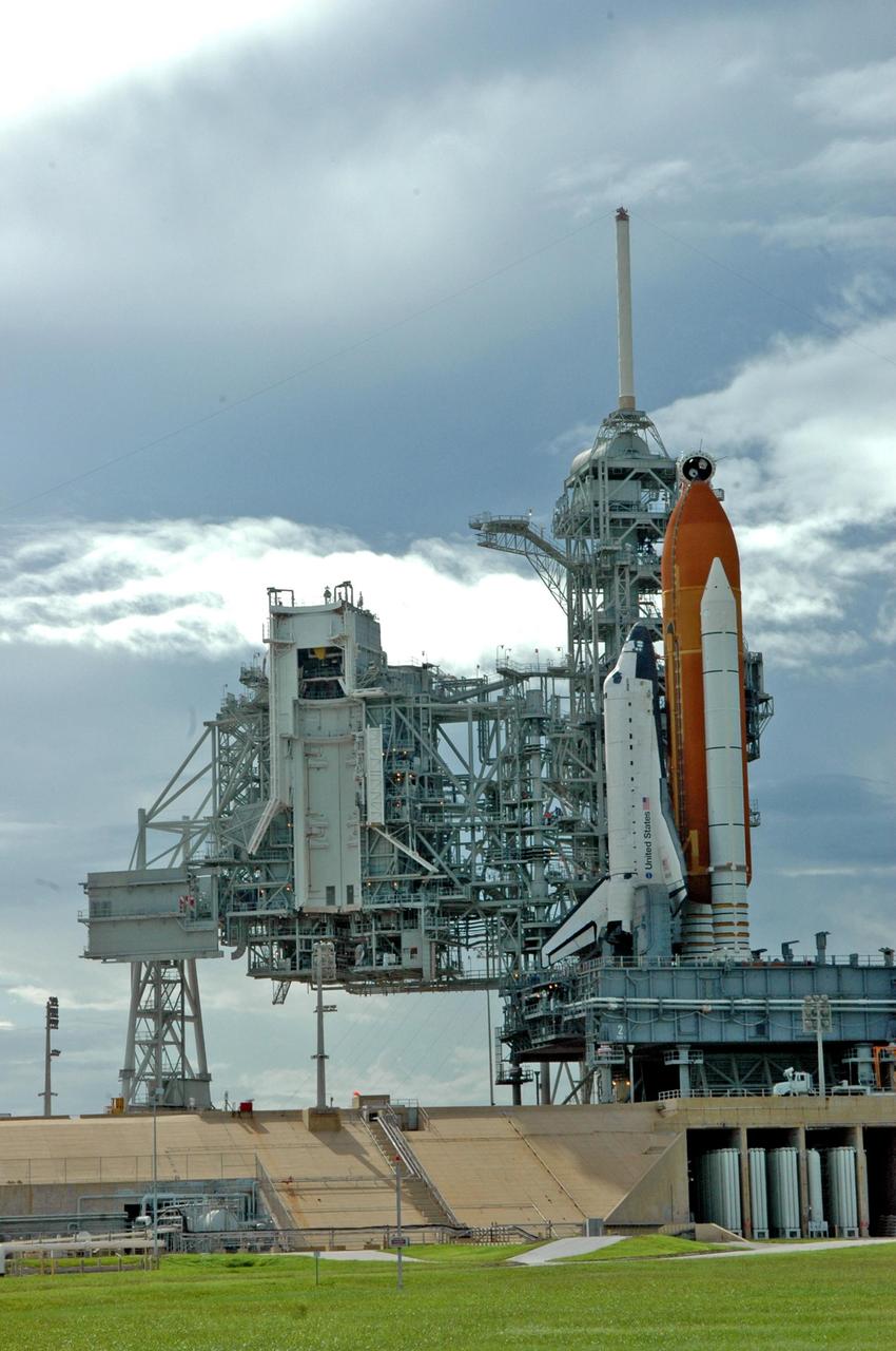 KENNEDY SPACE CENTER, FLA. - The rotating service structure (left) on Launch Pad 39B is rolled back to reveal Space Shuttle Atlantis. The RSS provides protected access to the orbiter for changeout and servicing of payloads at the pad and then is rolled away before liftoff. Atlantis is scheduled to launch Sept. 6 at 12:29 p.m. EDT on mission STS-115. During the mission, Atlantis' astronauts will deliver and install the 17.5-ton, bus-sized P3/P4 integrated truss segment on the station. The girder-like truss includes a set of giant solar arrays, batteries and associated electronics and will provide one-fourth of the total power-generation capability for the completed station. This mission is the 116th space shuttle flight, the 27th flight for orbiter Atlantis, and the 19th U.S. flight to the International Space Station. STS-115 is scheduled to last 11 days with a planned KSC landing at about 8:03 a.m. EDT on Sept. 17. Photo credit: NASA/Ken Thornsley