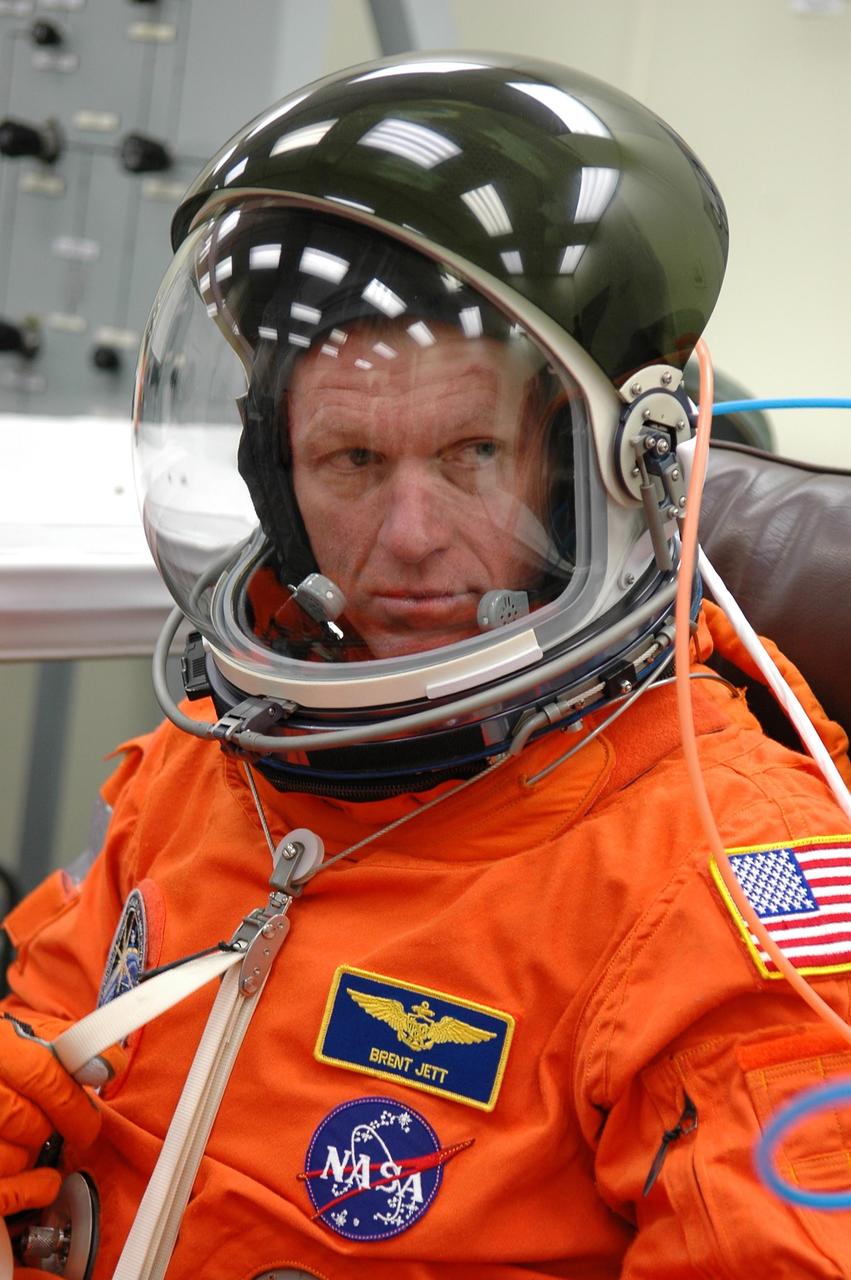 KENNEDY SPACE CENTER, FLA. -  In the Operations and Checkout Building at NASA Kennedy Space Center, STS-115 Commander Brent Jett looks reflective as he suits up for launch before heading to the launch pad.  Jett is making his fourth shuttle flight on this mission to the International Space Station aboard Space Shuttle Atlantis.  On its second attempt for launch, Atlantis is scheduled to lift off at 11:41 a.m. EDT today from Launch Pad 39B.  During the STS-115 mission, Atlantis' astronauts will deliver and install the 17.5-ton, bus-sized P3/P4 integrated truss segment on the station. The girder-like truss includes a set of giant solar arrays, batteries and associated electronics and will provide one-fourth of the total power-generation capability for the completed station. This mission is the 116th space shuttle flight, the 27th flight for orbiter Atlantis, and the 19th U.S. flight to the ISS. STS-115 is scheduled to last 11 days with a planned landing at KSC.  Photo credit: NASA/Kim Shiflett