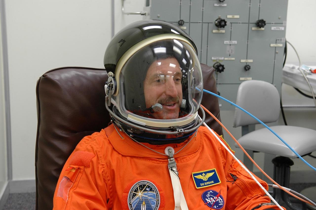 KENNEDY SPACE CENTER, FLA. -  During suitup in  the Operations and Checkout Building at NASA Kennedy Space Center, STS-115 Mission Specialist Daniel Burbank tests the communication system in his helmet.  Burbank is making his second shuttle flight on this mission to the International Space Station aboard Space Shuttle Atlantis.  On its second attempt for launch, Atlantis is scheduled to lift off at 11:41 a.m. EDT today from Launch Pad 39B.  During the STS-115 mission, Atlantis' astronauts will deliver and install the 17.5-ton, bus-sized P3/P4 integrated truss segment on the station. The girder-like truss includes a set of giant solar arrays, batteries and associated electronics and will provide one-fourth of the total power-generation capability for the completed station. This mission is the 116th space shuttle flight, the 27th flight for orbiter Atlantis, and the 19th U.S. flight to the ISS. STS-115 is scheduled to last 11 days with a planned landing at KSC.  Photo credit: NASA/Kim Shiflett