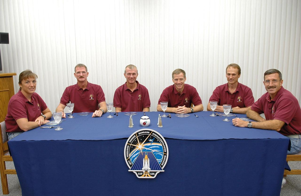 KENNEDY SPACE CENTER, FLA. -   After a week's delay of launching due to weather and technical issues, the crew of mission STS-115 have had the traditional breakfast before their third attempt to launch on Space Shuttle Atlantis.  Seated left to right are Mission Specialists Heidemarie Stefanyshyn-Piper and Joseph Tanner, Commander Brent Jett, Pilot Christopher Ferguson and Mission Specialists Steven MacLean and Daniel Burbank.  MacLean is with the Canadian Space Agency.  The launch attempt on Sept. 8 was scrubbed due to an issue with a fuel cut-off sensor system inside the external fuel tank. This is one of several systems that protect the shuttle's main engines by triggering their shutdown if fuel runs unexpectedly low.  Following the breakfast, the crew will don their launch suits before heading to Launch Pad 39B.  During the STS-115 mission, Atlantis' astronauts will deliver and install the 17.5-ton, bus-sized P3/P4 integrated truss segment on the station. The girder-like truss includes a set of giant solar arrays, batteries and associated electronics and will provide one-fourth of the total power-generation capability for the completed station. This mission is the 116th space shuttle flight, the 27th flight for orbiter Atlantis, and the 19th U.S. flight to the ISS. STS-115 is scheduled to last 11 days with a planned landing at KSC.  Photo credit: NASA/Kim Shiflett