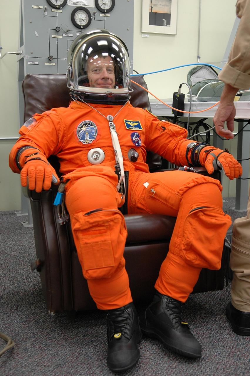 KENNEDY SPACE CENTER, FLA. - In the Operations and Checkout Building at NASA Kennedy Space Center, STS-115 Pilot Christopher Ferguson finishes suiting up for another attempt at liftoff.  The launch attempt on Sept. 8 was scrubbed due to an issue with a fuel cut-off sensor system inside the external fuel tank. This is one of several systems that protect the shuttle's main engines by triggering their shutdown if fuel runs unexpectedly low.  During the STS-115 mission, Atlantis' astronauts will deliver and install the 17.5-ton, bus-sized P3/P4 integrated truss segment on the station. The girder-like truss includes a set of giant solar arrays, batteries and associated electronics and will provide one-fourth of the total power-generation capability for the completed station. This mission is the 116th space shuttle flight, the 27th flight for orbiter Atlantis, and the 19th U.S. flight to the ISS. STS-115 is scheduled to last 11 days with a planned landing at KSC.  Photo credit: NASA/Kim Shiflett