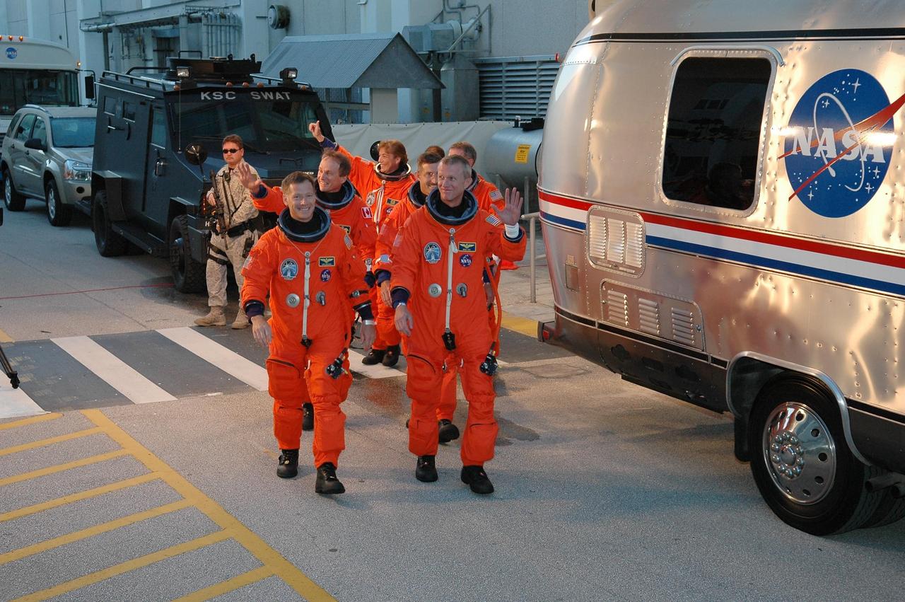 KENNEDY SPACE CENTER, FLA. - The STS-115 mission crew respond to well-wishers as they head to the Astrovan for the ride to Launch Pad 39B.  From left are Pilot Christopher Ferguson, Mission Specialists Steven MacLean, Heidemarie Stefanyshyn-Piper, Daniel Burbank and Joseph Tanner (hidden), and Commander Brent Jett.  The crew is eager for another attempt at liftoff after the Sept. 8 scrub.  The launch attempt on Sept. 8 was scrubbed due to an issue with a fuel cut-off sensor system inside the external fuel tank. This is one of several systems that protect the shuttle's main engines by triggering their shutdown if fuel runs unexpectedly low.  During the STS-115 mission, Atlantis' astronauts will deliver and install the 17.5-ton, bus-sized P3/P4 integrated truss segment on the station. The girder-like truss includes a set of giant solar arrays, batteries and associated electronics and will provide one-fourth of the total power-generation capability for the completed station. This mission is the 116th space shuttle flight, the 27th flight for orbiter Atlantis, and the 19th U.S. flight to the ISS. STS-115 is scheduled to last 11 days with a planned landing at KSC.  Photo credit: NASA/Kim Shiflett