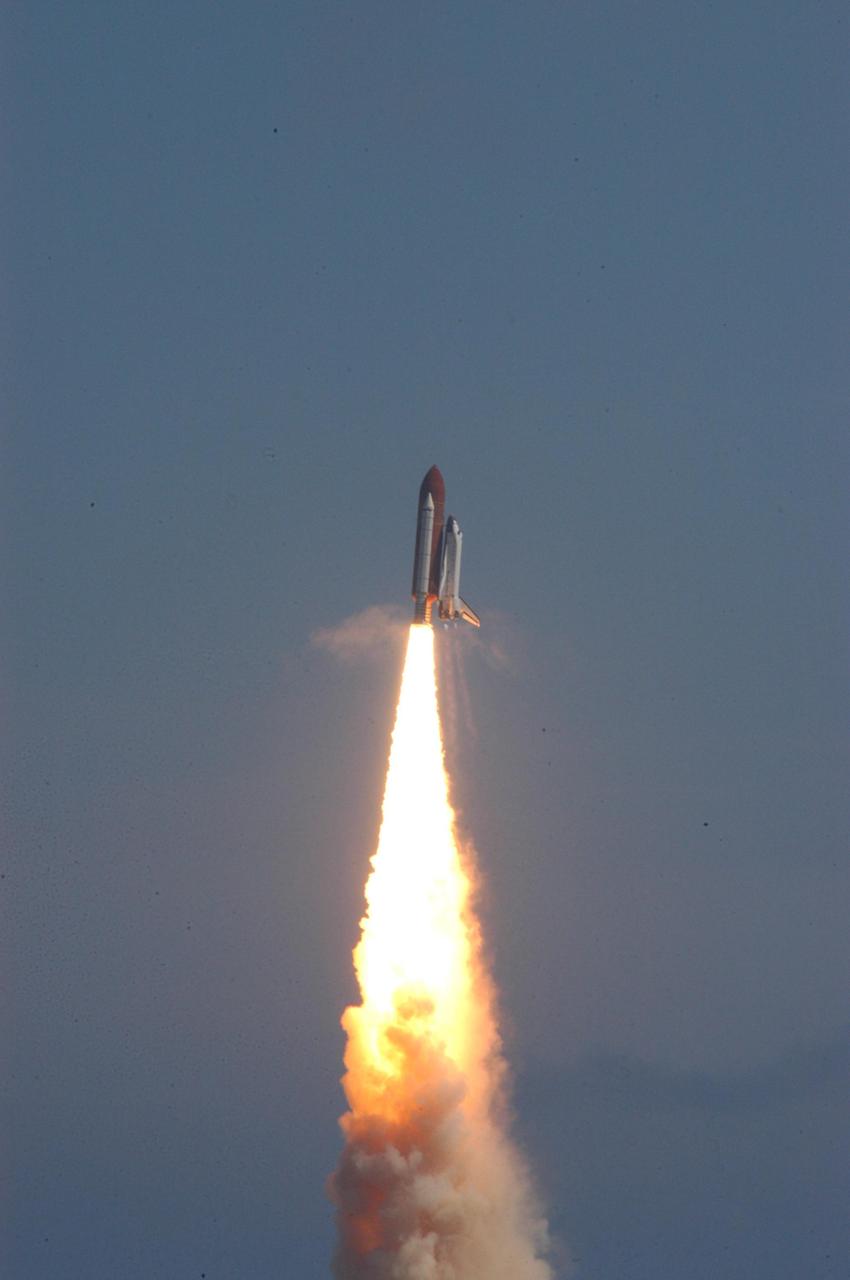 KENNEDY SPACE CENTER, FLA. - The fiery launch of Space Shuttle Atlantis makes a perfect picture against the blue Florida sky as Atlantis heads for a rendezvous with the International Space Station on mission STS-115. After launch attempts were scrubbed Aug. 27 and 29 and Sept. 3 and 8 due to weather and technical concerns,  this launch was executed perfectly.  During the STS-115 mission, Atlantis' astronauts will deliver and install the 17.5-ton, bus-sized P3/P4 integrated truss segment on the station. The girder-like truss includes a set of giant solar arrays, batteries and associated electronics and will provide one-fourth of the total power-generation capability for the completed station. This mission is the 116th space shuttle flight, the 27th flight for orbiter Atlantis, and the 19th U.S. flight to the ISS. STS-115 is scheduled to last 11 days with a planned landing at KSC.  Photo credit: NASA/George Shelton