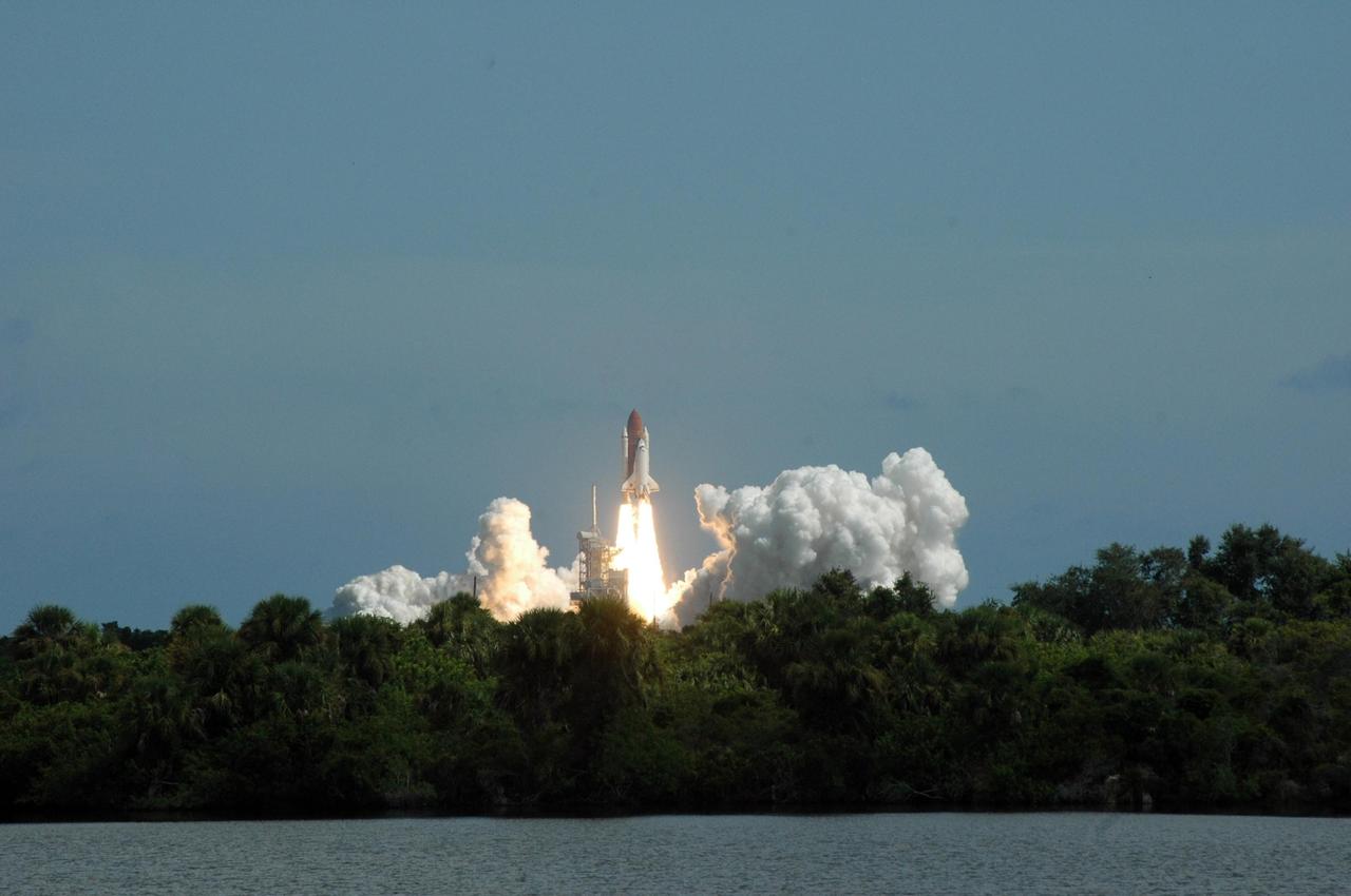 KENNEDY SPACE CENTER, FLA. -As if leaping out from amidst the woods, Space Shuttle Atlantis roars off Launch Pad 39B for a rendezvous with the International Space Station on mission STS-115.  Liftoff was on-time at 11:14:55 a.m. EDT.  After launch attempts were scrubbed Aug. 27 and 29 and Sept. 3 and 8 due to weather and technical concerns,  this launch was executed perfectly.  Mission STS-115 is the 116th space shuttle flight, the 27th flight for orbiter Atlantis, and the 19th U.S. flight to the International Space Station. During the mission, Atlantis' astronauts will deliver and install the 17.5-ton, bus-sized P3/P4 integrated truss segment on the station. The girder-like truss includes a set of giant solar arrays, batteries and associated electronics and will provide one-fourth of the total power-generation capability for the completed station. STS-115 is scheduled to last 11 days with a planned landing at KSC. Photo credit: NASA/Ken Thornsley
