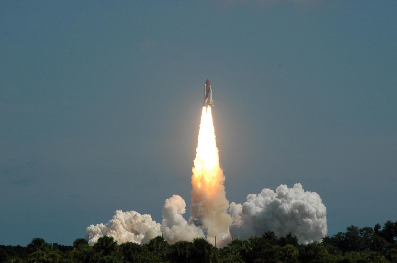 KENNEDY SPACE CENTER, FLA. - Flaming rockets propel Space Shuttle Atlantis away from the smoke and steam below and into the sky for a rendezvous with the International Space Station on mission STS-115.  Liftoff was on-time at 11:14:55 a.m. EDT.  After launch attempts were scrubbed Aug. 27 and 29 and Sept. 3 and 8 due to weather and technical concerns,  this launch was executed perfectly.   Mission STS-115 is the 116th space shuttle flight, the 27th flight for orbiter Atlantis, and the 19th U.S. flight to the International Space Station. During the mission, Atlantis' astronauts will deliver and install the 17.5-ton, bus-sized P3/P4 integrated truss segment on the station. The girder-like truss includes a set of giant solar arrays, batteries and associated electronics and will provide one-fourth of the total power-generation capability for the completed station. STS-115 is scheduled to last 11 days with a planned landing at KSC. Photo credit: NASA/Ken Thornsley