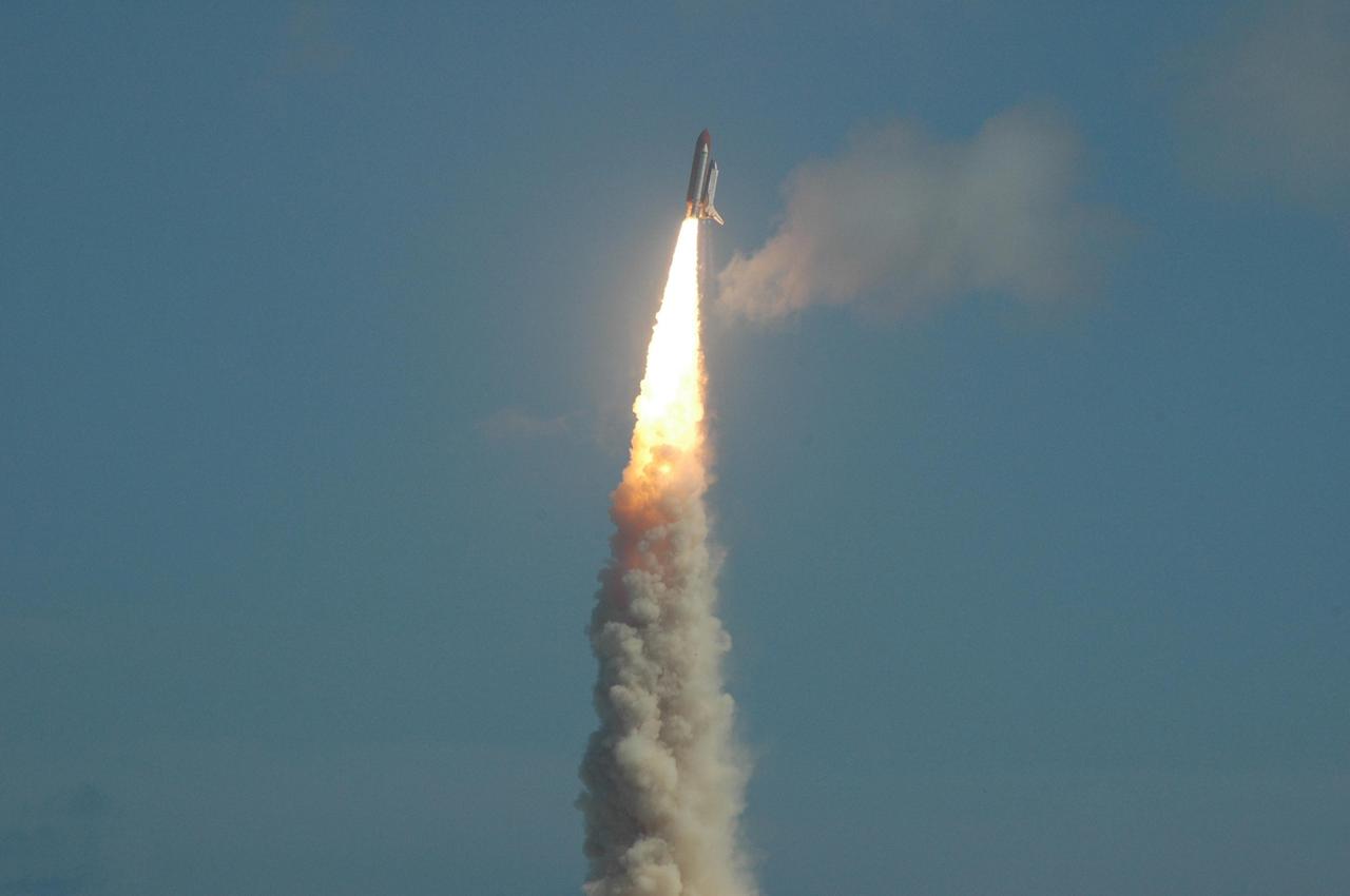 KENNEDY SPACE CENTER, FLA. -  Through a slight haze of clouds, Space Shuttle Atlantis hurtles toward space for a rendezvous with the International Space Station on mission STS-115.  Liftoff was on-time at 11:14:55 a.m. EDT.  After launch attempts were scrubbed Aug. 27 and 29 and Sept. 3 and 8 due to weather and technical concerns,  this launch was executed perfectly.  Mission STS-115 is the 116th space shuttle flight, the 27th flight for orbiter Atlantis, and the 19th U.S. flight to the International Space Station. During the mission, Atlantis' astronauts will deliver and install the 17.5-ton, bus-sized P3/P4 integrated truss segment on the station. The girder-like truss includes a set of giant solar arrays, batteries and associated electronics and will provide one-fourth of the total power-generation capability for the completed station. STS-115 is scheduled to last 11 days with a planned landing at KSC. Photo credit: NASA/Ken Thornsley