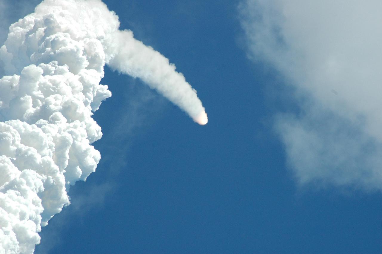 KENNEDY SPACE CENTER, FLA. -  Nearly obscured by its own contrail, Space Shuttle Atlantis hurtles toward space for a rendezvous with the International Space Station on mission STS-115.  Liftoff was on-time at 11:14:55 a.m. EDT.  After launch attempts were scrubbed Aug. 27 and 29 and Sept. 3 and 8 due to weather and technical concerns,  this launch was executed perfectly.  Mission STS-115 is the 116th space shuttle flight, the 27th flight for orbiter Atlantis, and the 19th U.S. flight to the International Space Station. During the mission, Atlantis' astronauts will deliver and install the 17.5-ton, bus-sized P3/P4 integrated truss segment on the station. The girder-like truss includes a set of giant solar arrays, batteries and associated electronics and will provide one-fourth of the total power-generation capability for the completed station. STS-115 is scheduled to last 11 days with a planned landing at KSC. Photo credit: NASA/Ken Thornsley