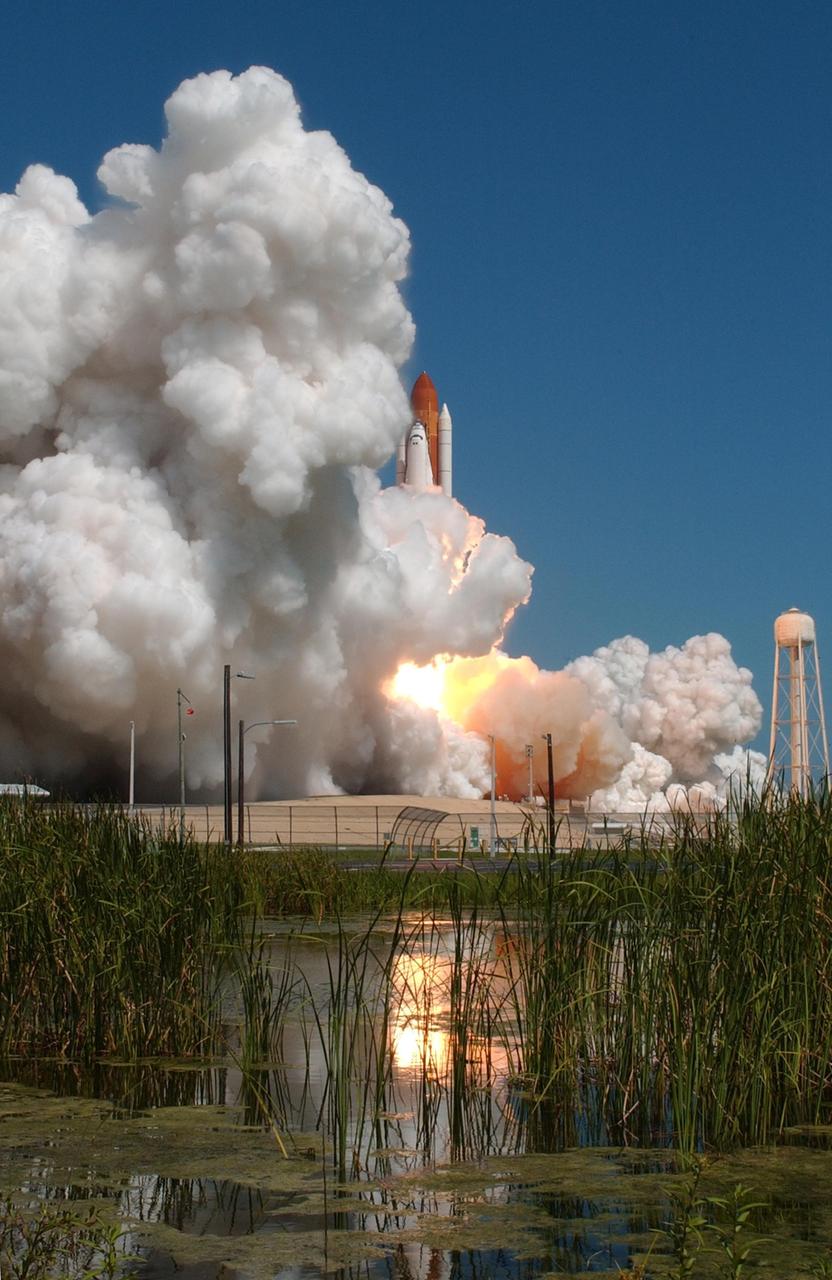 KENNEDY SPACE CENTER, FLA. -   Space Shuttle Atlantis appears enveloped in the smoke and steam created at liftoff from Launch Pad 39B.  Liftoff was on-time at 11:14:55 a.m. EDT.  Atlantis is heading for space and its rendezvous with the International Space Station on mission STS-115.  After launch attempts were scrubbed Aug. 27 and 29 and Sept. 3 and 8 due to weather and technical concerns,  this launch was executed perfectly.  Mission STS-115 is the 116th space shuttle flight, the 27th flight for orbiter Atlantis, and the 19th U.S. flight to the International Space Station. During the mission, Atlantis' astronauts will deliver and install the 17.5-ton, bus-sized P3/P4 integrated truss segment on the station. The girder-like truss includes a set of giant solar arrays, batteries and associated electronics and will provide one-fourth of the total power-generation capability for the completed station. STS-115 is scheduled to last 11 days with a planned landing at KSC. Photo credit: NASA/Sandra Joseph & Robert Murray