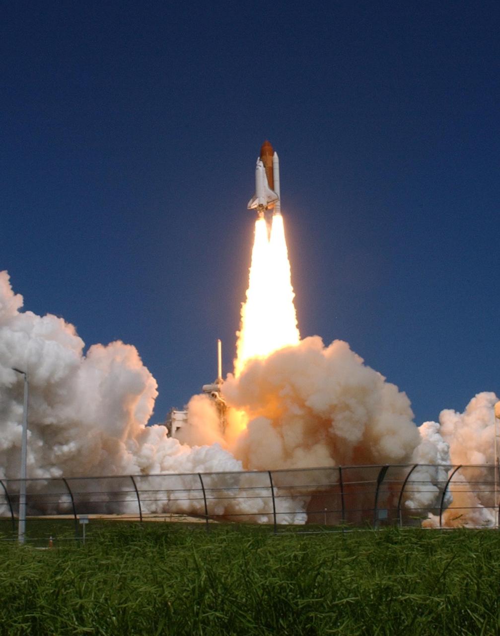 KENNEDY SPACE CENTER, FLA. -   Flaming rockets propel Space Shuttle Atlantis away from the smoke and steam below and into the sky for a rendezvous with the International Space Station on mission STS-115.  Liftoff was on-time at 11:14:55 a.m. EDT.  After launch attempts were scrubbed Aug. 27 and 29 and Sept. 3 and 8 due to weather and technical concerns,  this launch was executed perfectly.  Mission STS-115 is the 116th space shuttle flight, the 27th flight for orbiter Atlantis, and the 19th U.S. flight to the International Space Station. During the mission, Atlantis' astronauts will deliver and install the 17.5-ton, bus-sized P3/P4 integrated truss segment on the station. The girder-like truss includes a set of giant solar arrays, batteries and associated electronics and will provide one-fourth of the total power-generation capability for the completed station. STS-115 is scheduled to last 11 days with a planned landing at KSC. Photo credit: NASA/Sandra Joseph & Robert Murray