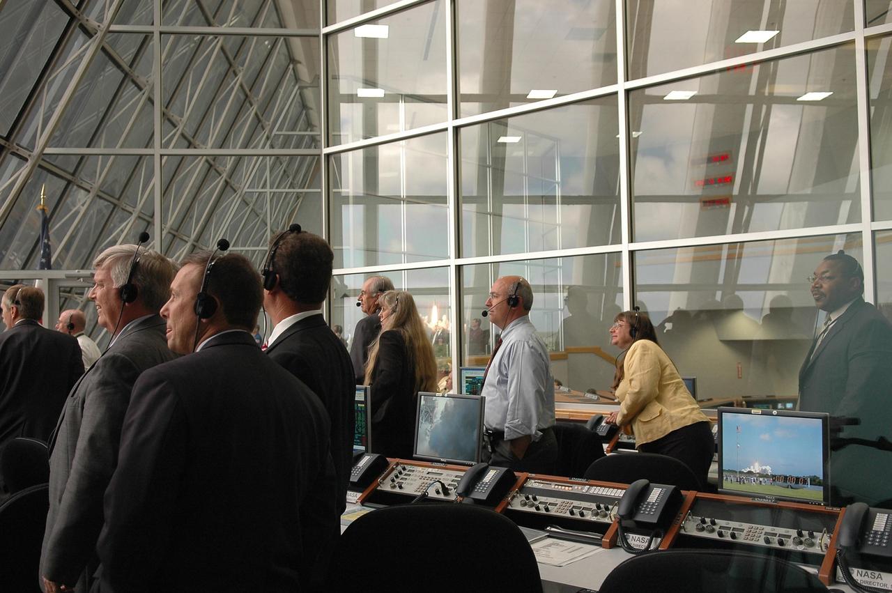 KENNEDY SPACE CENTER, FLA. -   Inside the Launch Control Center, NASA and KSC officials turn from their computers to watch through the broad windows the launch of Space Shuttle Atlantis on mission STS-115.  Second from left is Kennedy Space Center Director Jim Kennedy. Mission STS-115 is the 116th space shuttle flight, the 27th flight for orbiter Atlantis, and the 19th U.S. flight to the International Space Station. STS-115 is scheduled to last 11 days with a planned landing at KSC. Photo credit: NASA/Kim Shiflett