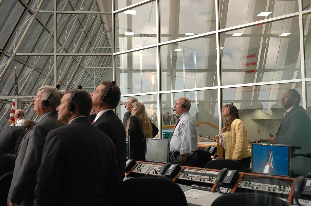 KENNEDY SPACE CENTER, FLA. -   Inside the Launch Control Center, NASA and KSC officials turn from their computers to watch through the broad windows the launch of Space Shuttle Atlantis on mission STS-115.  Second from left is Kennedy Space Center Director Jim Kennedy.  Mission STS-115 is the 116th space shuttle flight, the 27th flight for orbiter Atlantis, and the 19th U.S. flight to the International Space Station. STS-115 is scheduled to last 11 days with a planned landing at KSC. Photo credit: NASA/Kim Shiflett