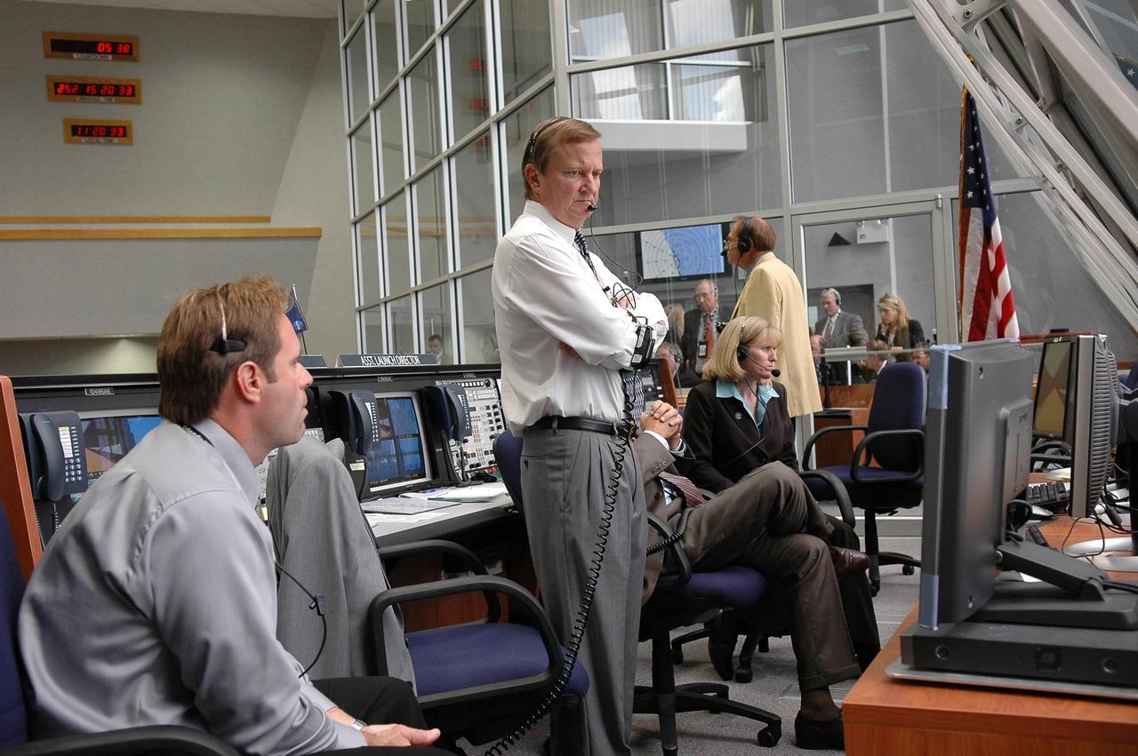 KENNEDY SPACE CENTER, FLA. -  Inside the Launch Control Center, Shuttle Launch Director Mike Leinbach (center, standing) watches the computer screen as cameras document Space Shuttle Atlantis' climb toward space on mission STS-115.  Mission STS-115 is the 116th space shuttle flight, the 27th flight for orbiter Atlantis, and the 19th U.S. flight to the International Space Station. sts-115 is scheduled to last 11 days with a planned landing at KSC. Photo credit: NASA/Kim Shiflett