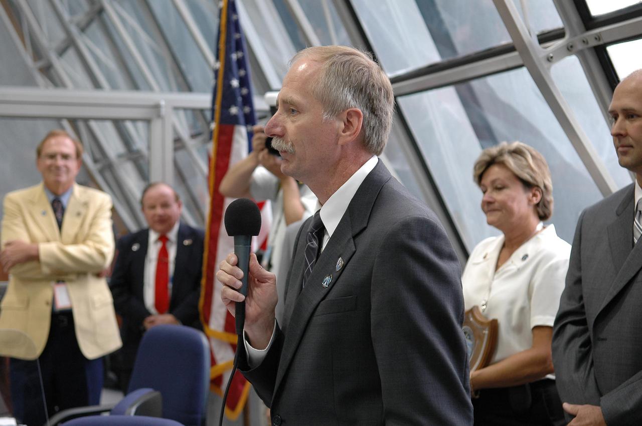 KENNEDY SPACE CENTER, FLA. -  Inside the Launch Control Center, Associate Administrator for Space Operations Mission William Gerstenmaier congratulates the launch team after the liftoff of Space Shuttle Atlantis on mission STS-115.  Behind him, at right, are Pat Leslie and Robbie Ashley, STS-115 payload manager.  Mission STS-115 is the 116th space shuttle flight, the 27th flight for orbiter Atlantis, and the 19th U.S. flight to the International Space Station. Mission STS-115 is scheduled to last 11 days with a planned landing at KSC. Photo credit: NASA/Kim Shiflett