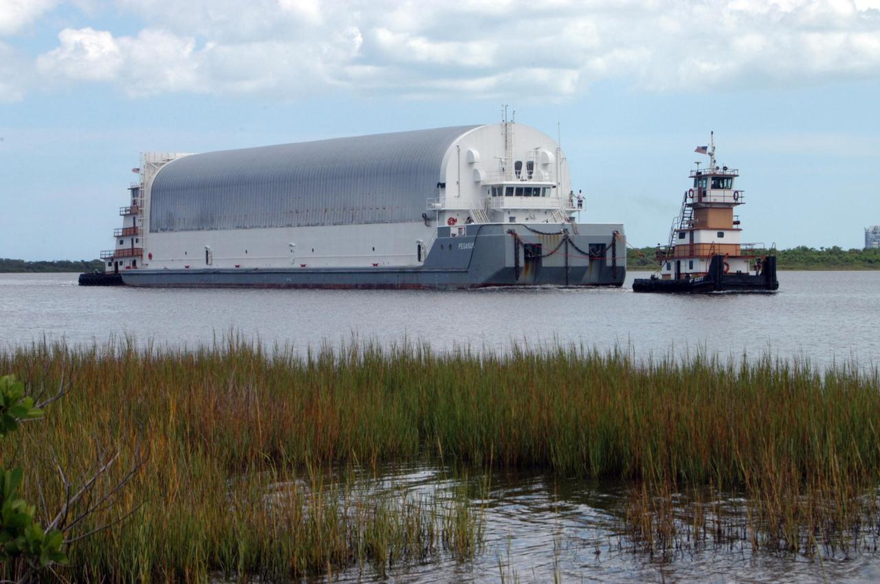KENNEDY SPACE CENTER, FLA. -   The Pegasus barge is towed toward the turn basin dock in the Launch Complex 39 Area at NASA's Kennedy Space Center.  Onboard the barge is the external tank No. 123, designated to launch Space Shuttle Discovery on mission STS-116 in December.   The tank, which was shipped from NASA's Michoud Assembly Facility in New Orleans, has undergone major safety changes, including removal of the protuberance air load ramps. Mission STS-116 will deliver the P5 truss segment, a SPACEHAB module and other key components to the International Space Station.  Launch is currently scheduled no earlier than Dec. 14.  Photo credit: NASA/George Shelton