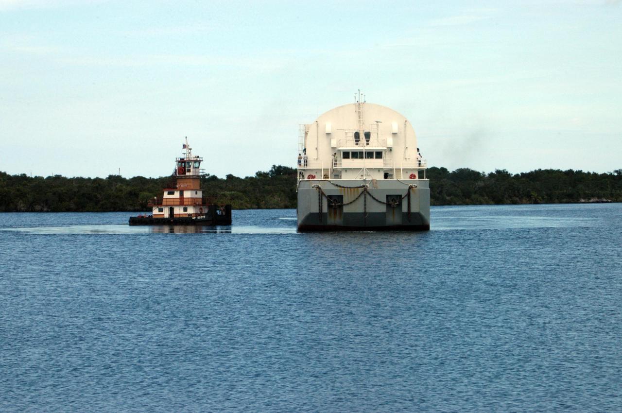 KENNEDY SPACE CENTER, FLA. - One of the boats towing the Pegasus barge moves beside it to help with docking at the turn basin in the Launch Complex 39 Area at NASA's Kennedy Space Center. Onboard the barge is the external tank No. 123, designated to launch Space Shuttle Discovery on mission STS-116 in December. The tank, which was shipped from NASA's Michoud Assembly Facility in New Orleans, has undergone major safety changes, including removal of the protuberance air load ramps. Mission STS-116 will deliver the P5 truss segment, a SPACEHAB module and other key components to the International Space Station. Launch is currently scheduled no earlier than Dec. 14. Photo credit: NASA/George Shelton