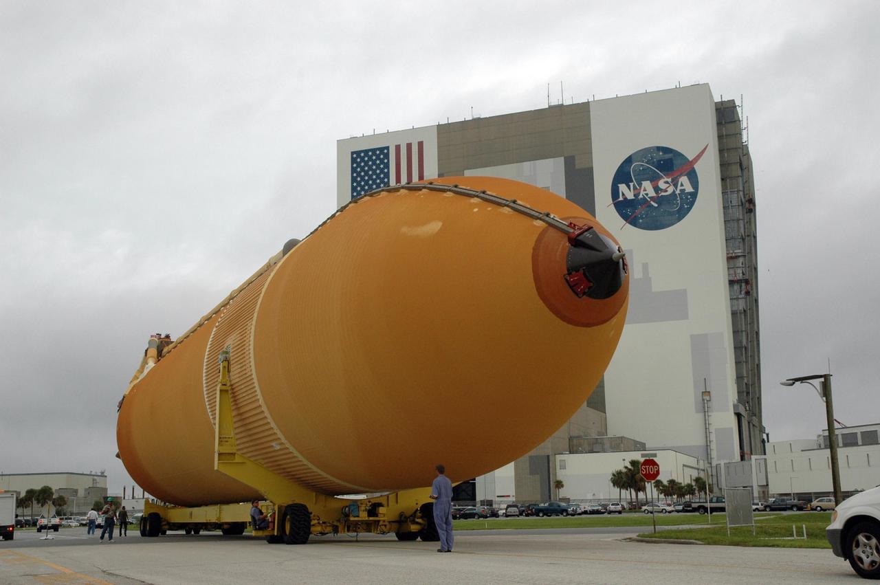 KENNEDY SPACE CENTER, FLA. - External tank No. 123 makes the turn toward the Vehicle Assembly Building after being offloaded from the Pegasus barge in the turn basin at the Launch Complex 39 Area. Once inside the VAB, the tank will be lifted into a checkout cell for further work. Shipped from NASA's Michoud Assembly Facility in New Orleans, the tank has undergone major safety changes, including removal of the protuberance air load ramps. It is designated to launch Space Shuttle Discovery on mission STS-116 in December. Mission STS-116 will deliver the P5 truss segment, a SPACEHAB module and other key components to the International Space Station. Launch is currently scheduled no earlier than Dec. 14. Photo credit: NASA/Jack Pfaller