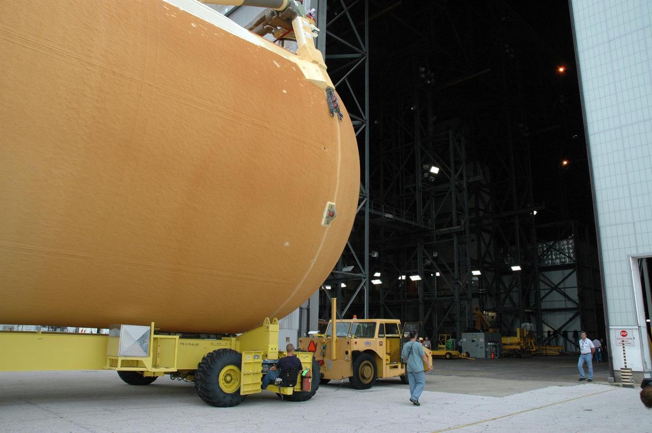 KENNEDY SPACE CENTER, FLA. -  External tank No. 123 heads into the open doorway of the Vehicle Assembly Building. Once inside the VAB, the tank will be lifted into a checkout cell for further work.  Shipped from NASA's Michoud Assembly Facility in New Orleans aboard the Pegasus barge, the tank has undergone major safety changes, including removal of the protuberance air load ramps.  It is designated to launch Space Shuttle Discovery on mission STS-116 in December.  Mission STS-116 will deliver the P5 truss segment, a SPACEHAB module and other key components to the International Space Station.  Launch is currently scheduled no earlier than Dec. 14.  Photo credit: NASA/Jack Pfaller