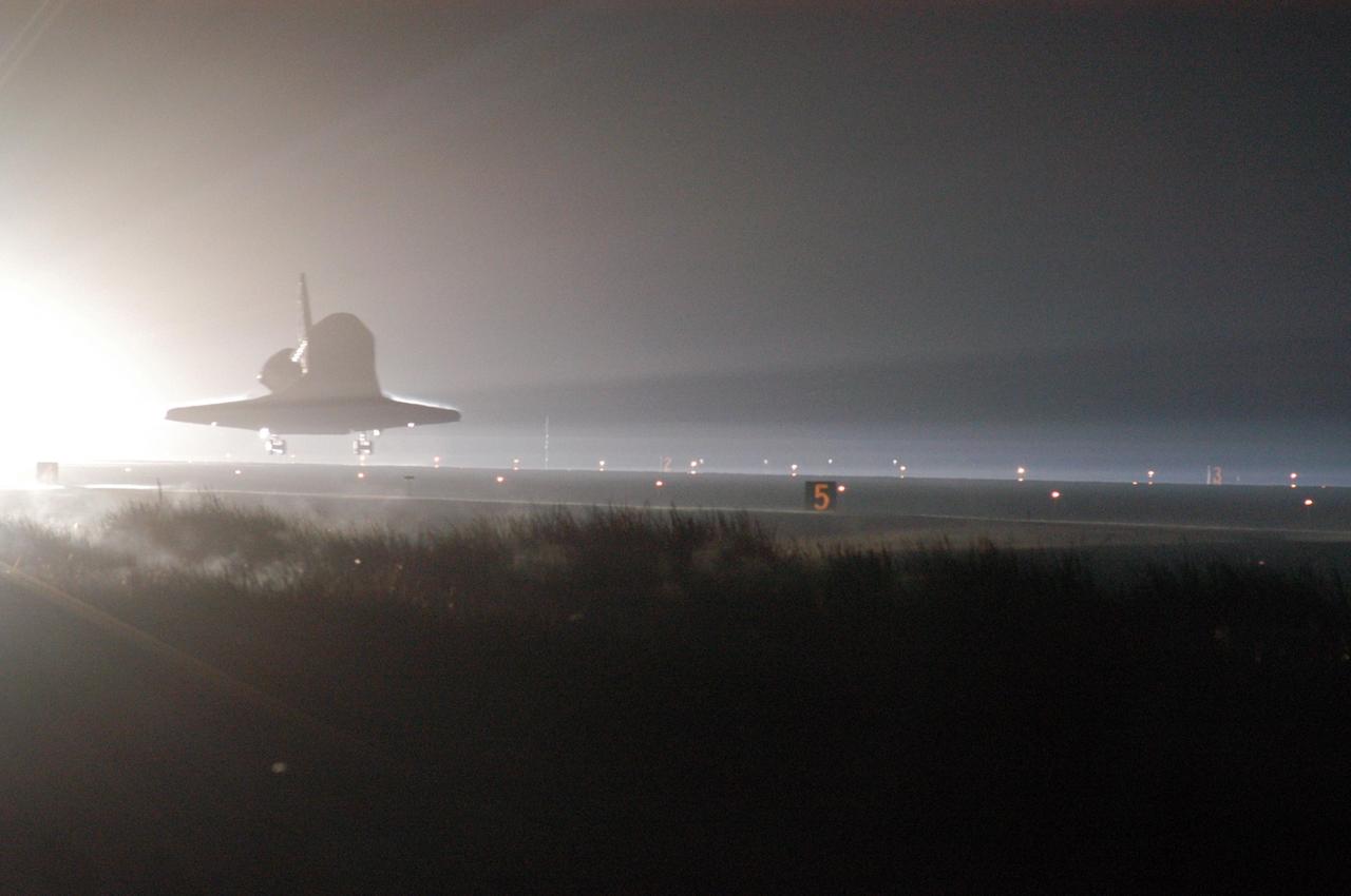 KENNEDY SPACE CENTER, FLA. -   Just before dawn, Atlantis nears touchdown on Runway 33 at NASA's Kennedy Space Center, concluding mission STS-115.  Aboard are Commander Brent Jett, Pilot Christopher Ferguson, and Mission Specialists Joseph Tanner, David Burbank, Heidemarie Stefanyshyn-Piper and Steven MacLean, who represents the Canadian Space Agency.  During the mission, Tanner, McLean, Burbank and Piper completed three spacewalks to attach the P3/P4 integrated truss structure to the International Space Station.  Main gear touchdown was at 6:21:30 a.m. EDT.  Nose gear touchdown was at 6:21:36 a.m. and wheel stop was at 6:22:16 a.m.  At touchdown -- nominally about 2,500 ft. beyond the runway threshold -- the orbiter is traveling at a speed ranging from 213 to 226 mph. Atlantis traveled 4.9 million miles, landing on orbit 187. Mission elapsed time was 11 days, 19 hours, six minutes. This is the 15th night landing at KSC and the 23rd night landing overall.  Photo credit: NASA/George Shelton